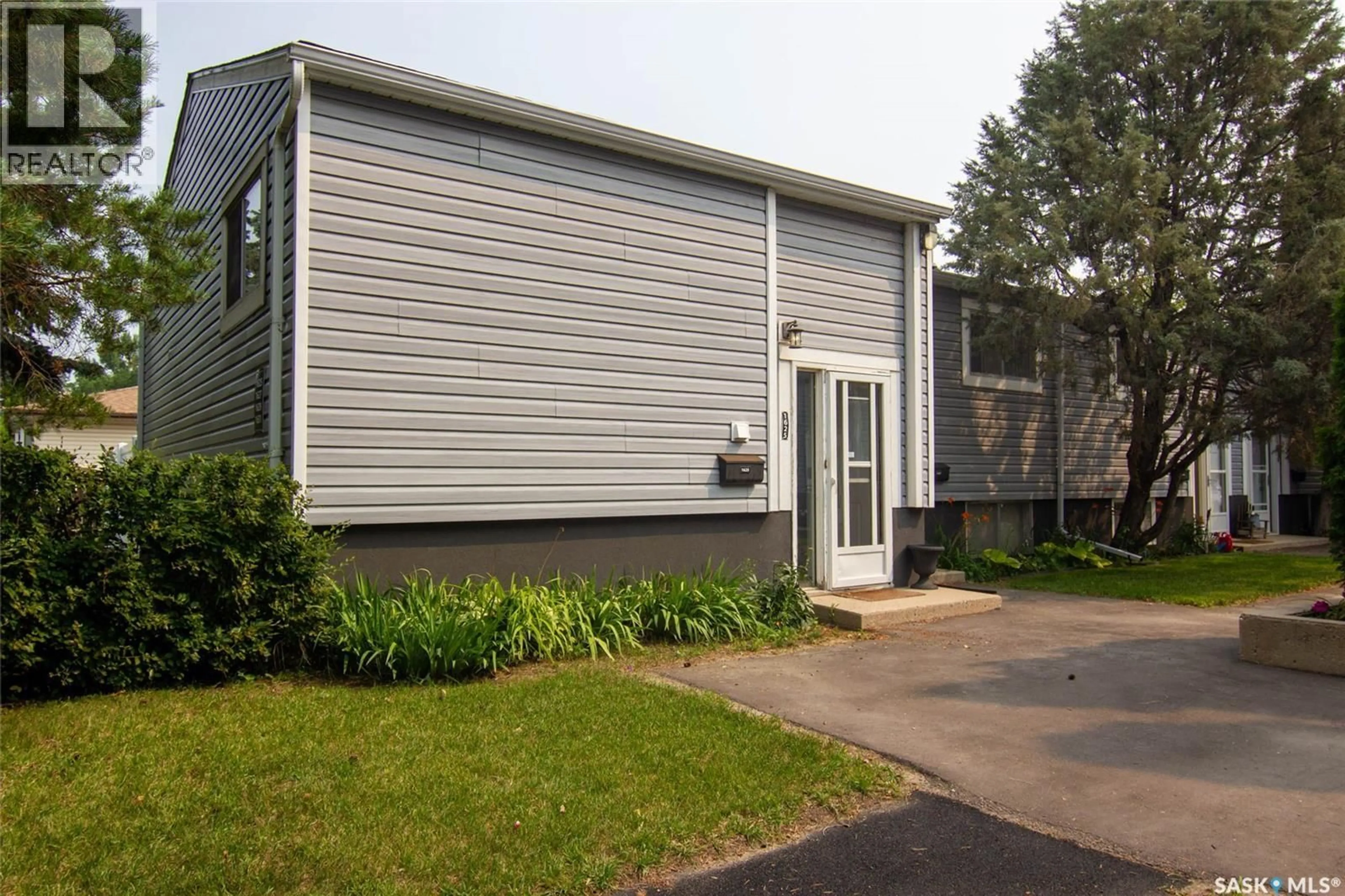 Home with vinyl exterior material, street for 1625 THOMPSON AVENUE, Saskatoon Saskatchewan S7N1Y2