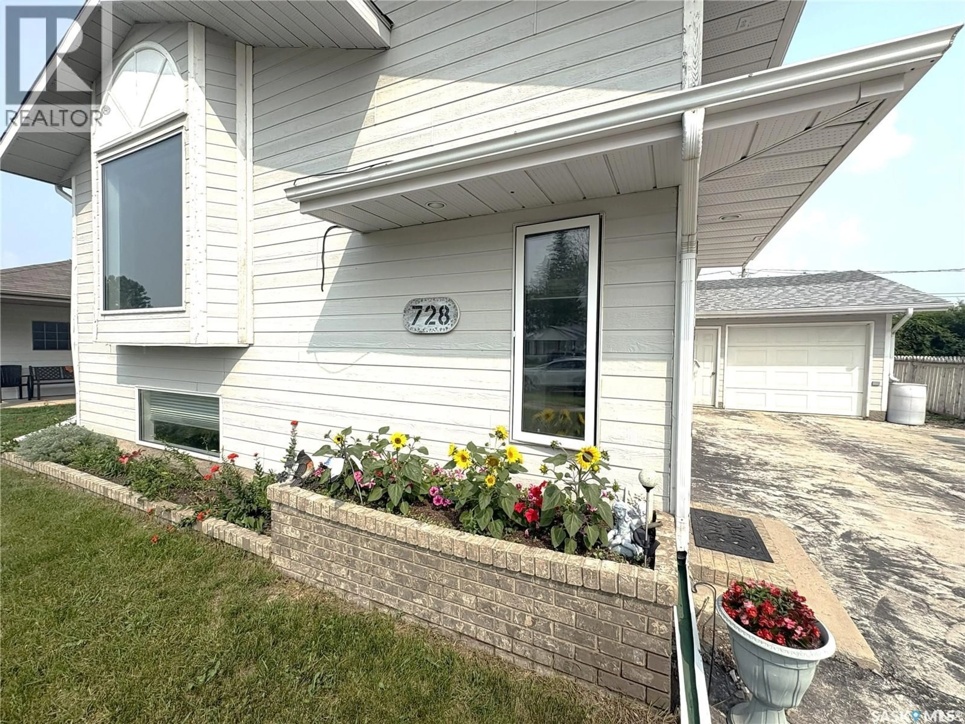 Home with vinyl exterior material, street for 728 14TH STREET, Humboldt Saskatchewan S0K2A0