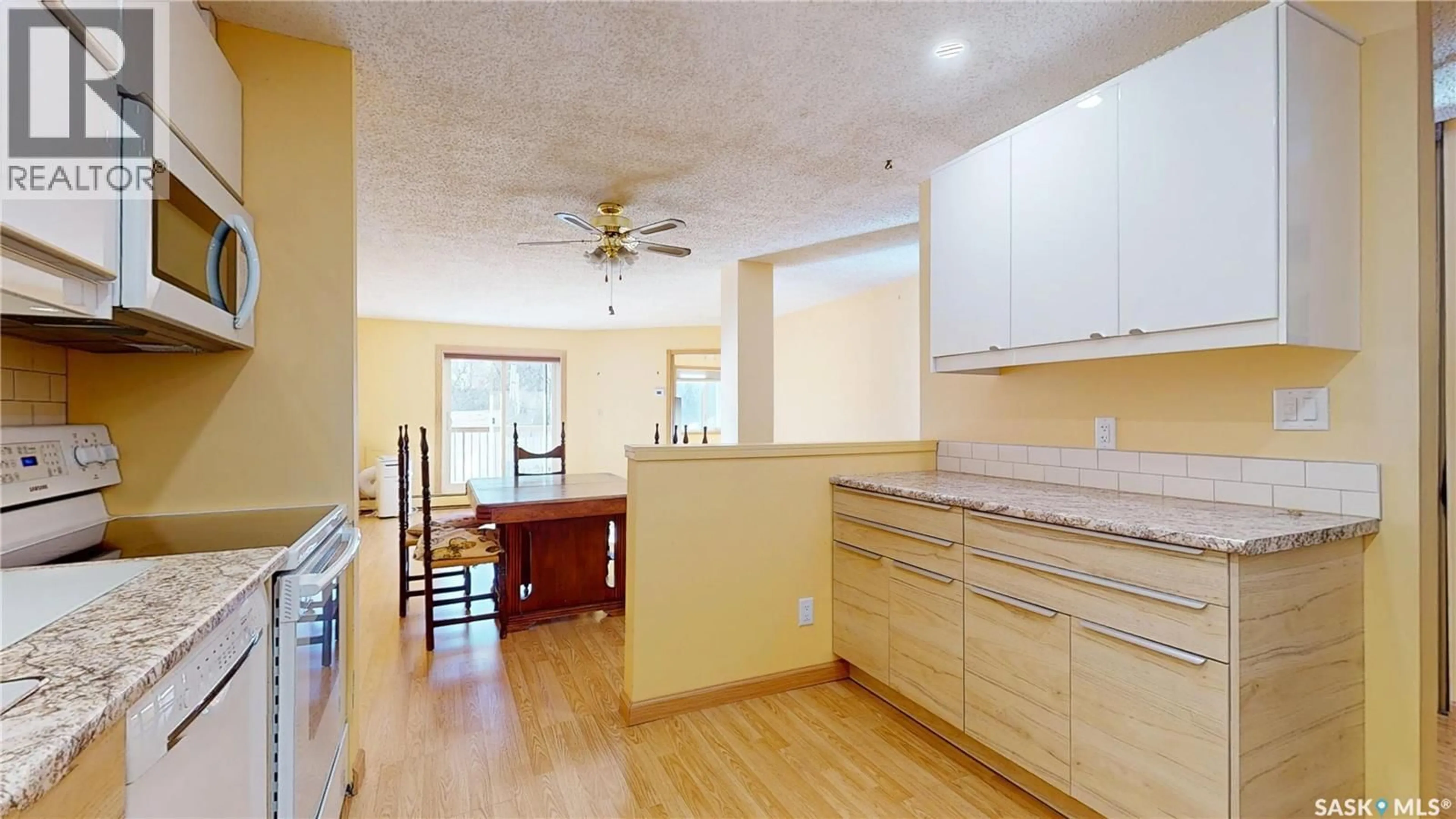 Open concept kitchen, wood/laminate floor for 107 - 2727 VICTORIA AVENUE, Regina Saskatchewan S4T1K4