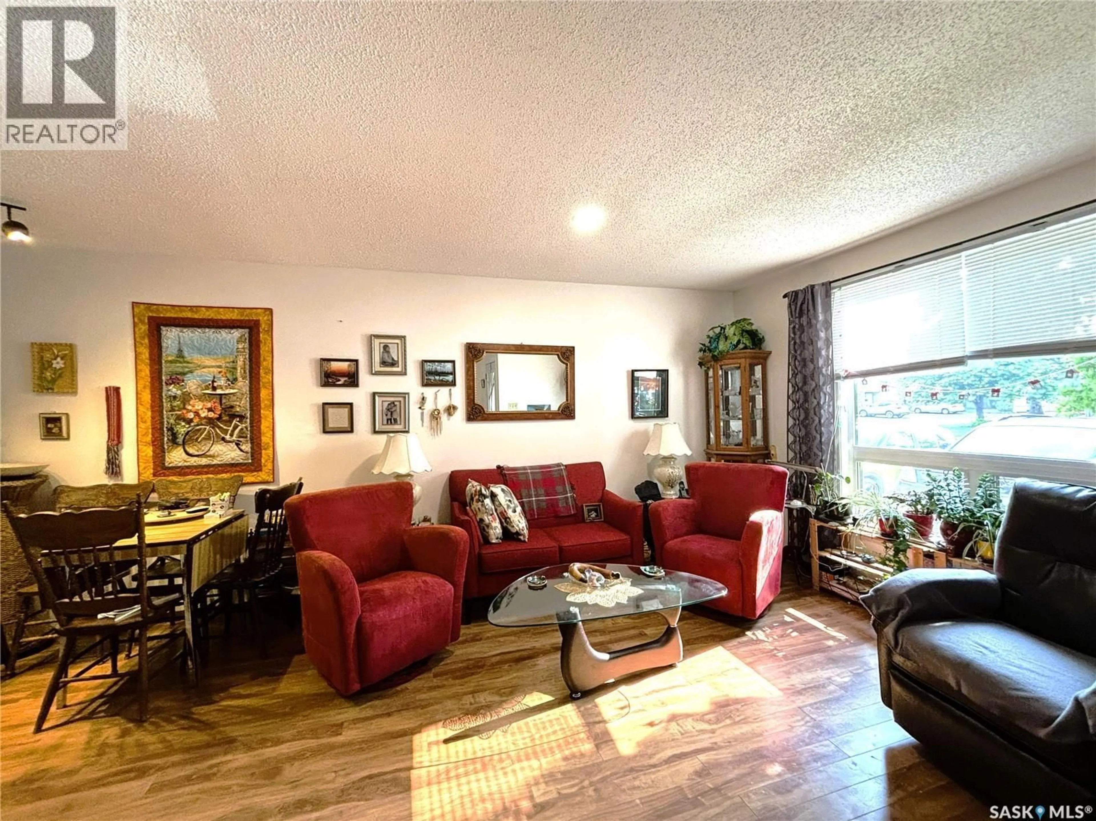 Living room with furniture, wood/laminate floor for 1128 - 127 MCKERCHER DRIVE, Saskatoon Saskatchewan S7H4Y7