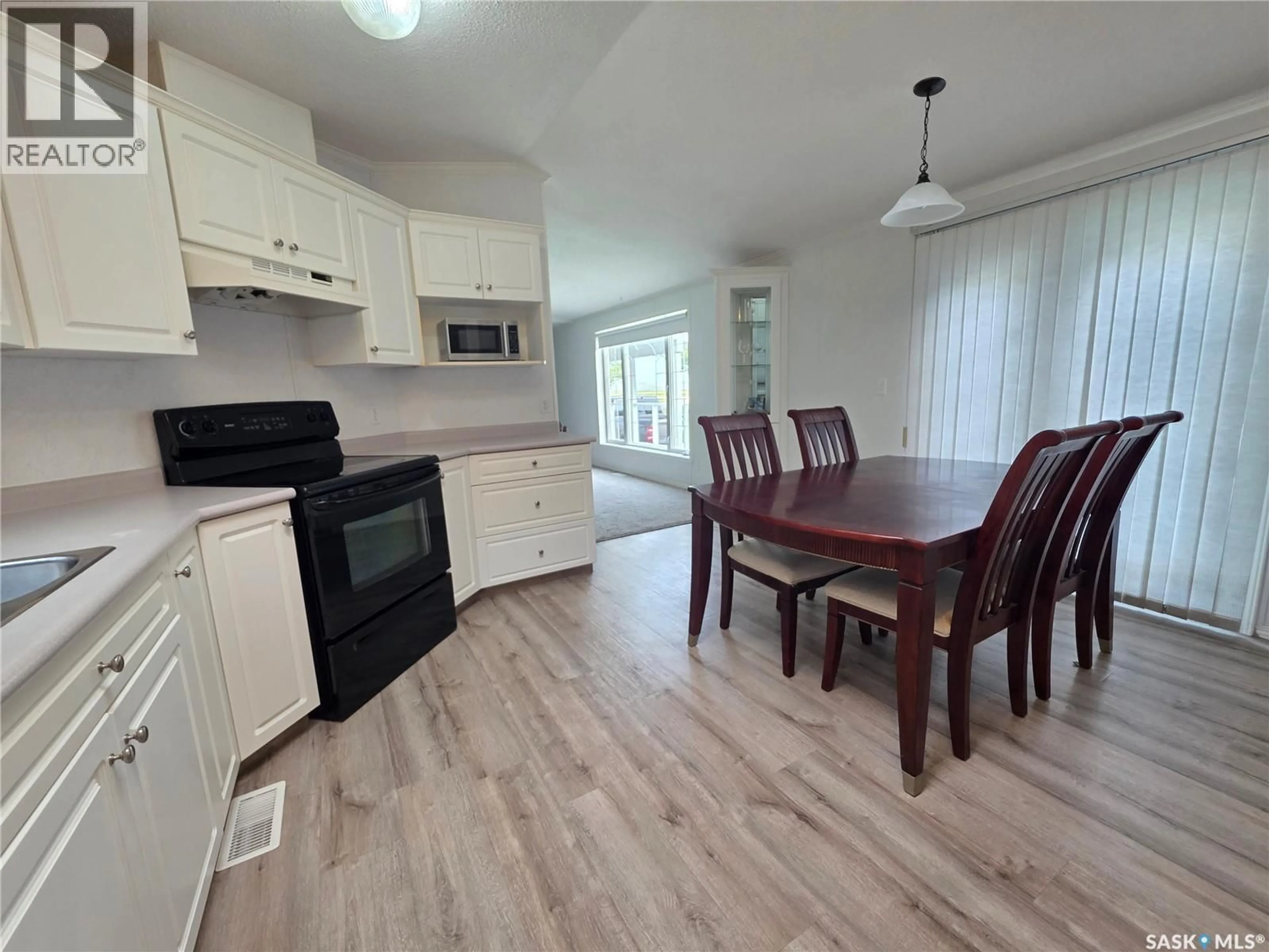 Open concept kitchen, wood/laminate floor for 63 PRAIRIE SUN COURT, Swift Current Saskatchewan S9H3X6