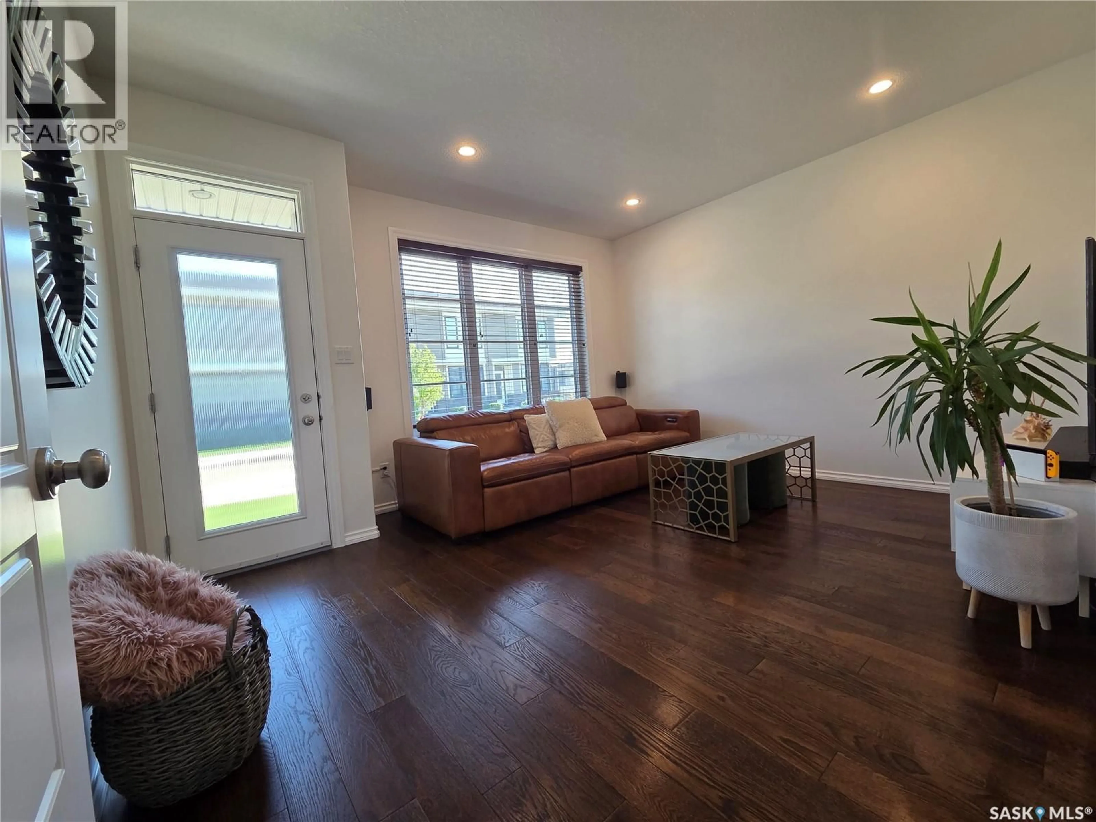 Living room with furniture, wood/laminate floor for 204 - 3229 ELGAARD DRIVE, Regina Saskatchewan S4X0L2