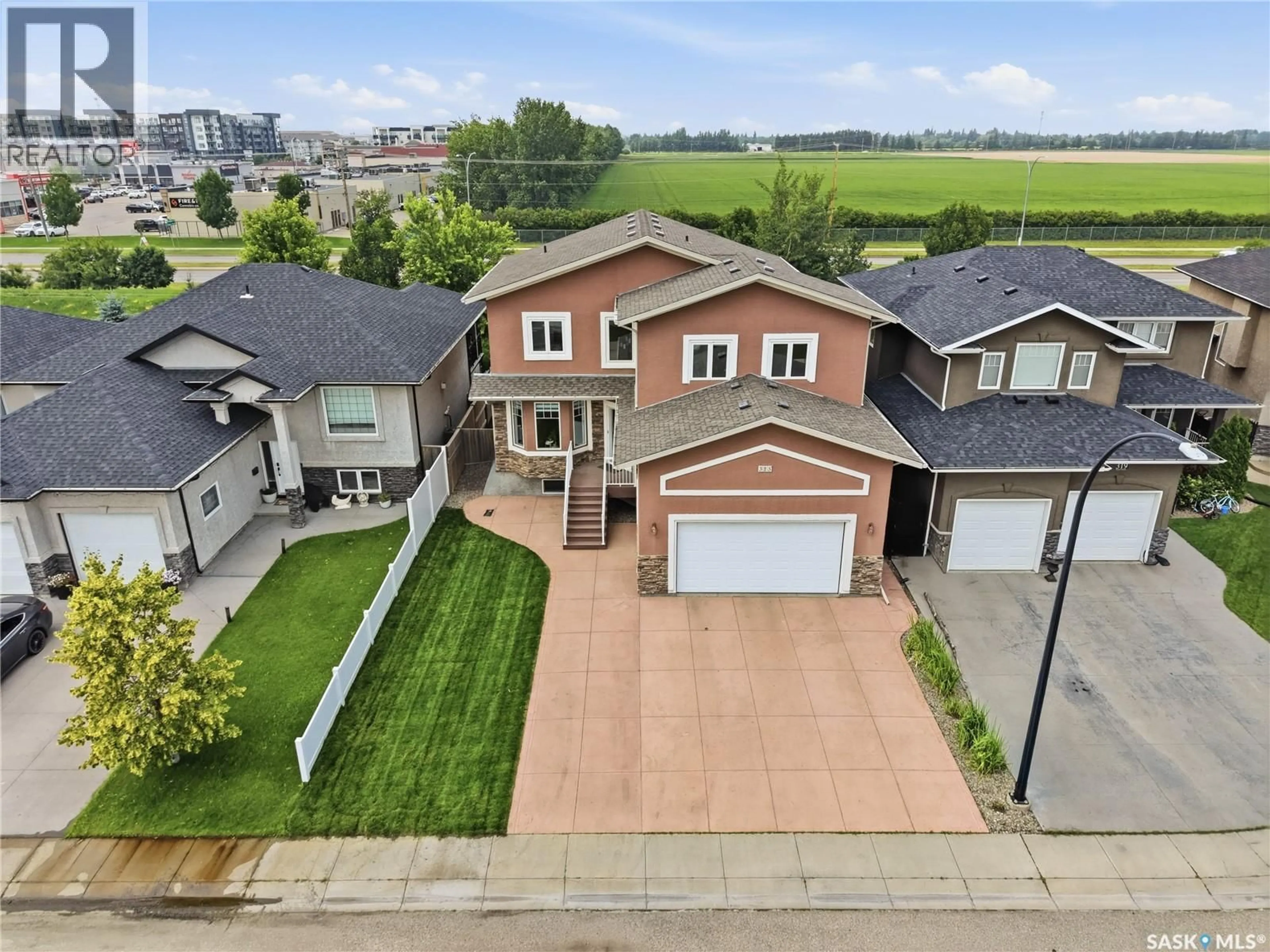 A pic from outside/outdoor area/front of a property/back of a property/a pic from drone, street for 315 WATERS CRESCENT, Saskatoon Saskatchewan S7W0A5