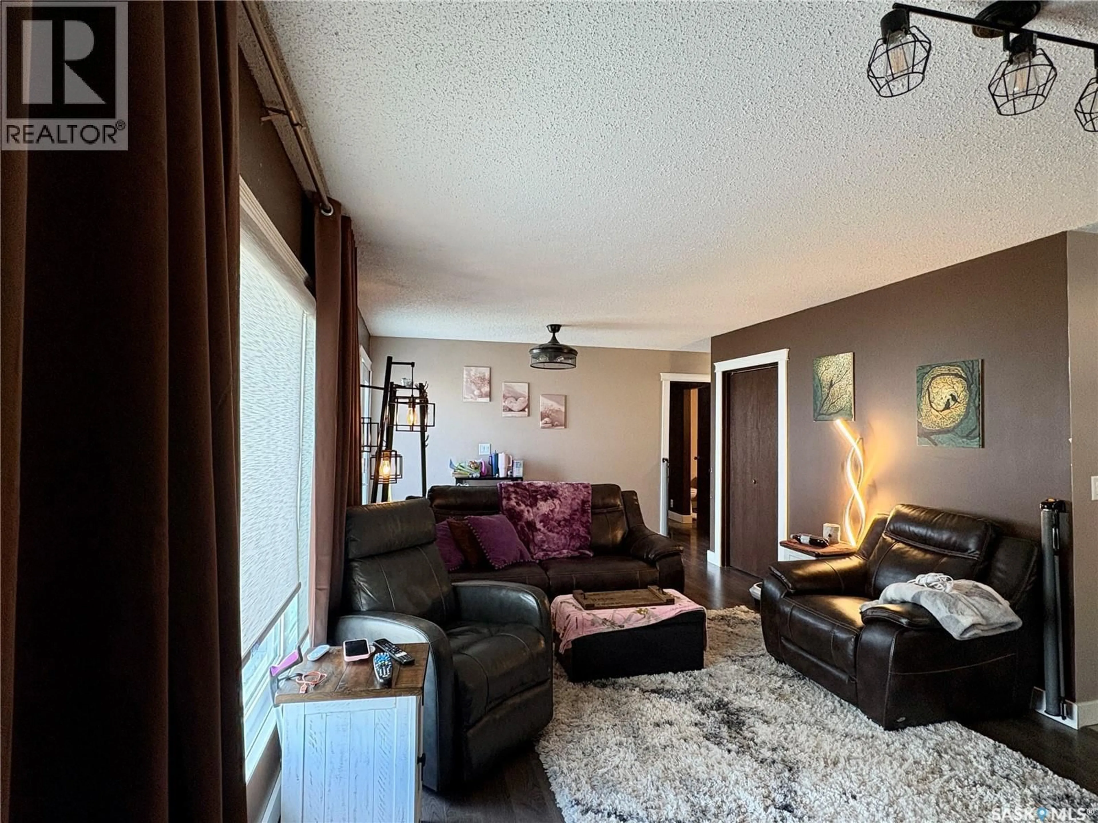 Living room with furniture, wood/laminate floor for 105 5TH AVENUE, Hodgeville Saskatchewan S0H2B0