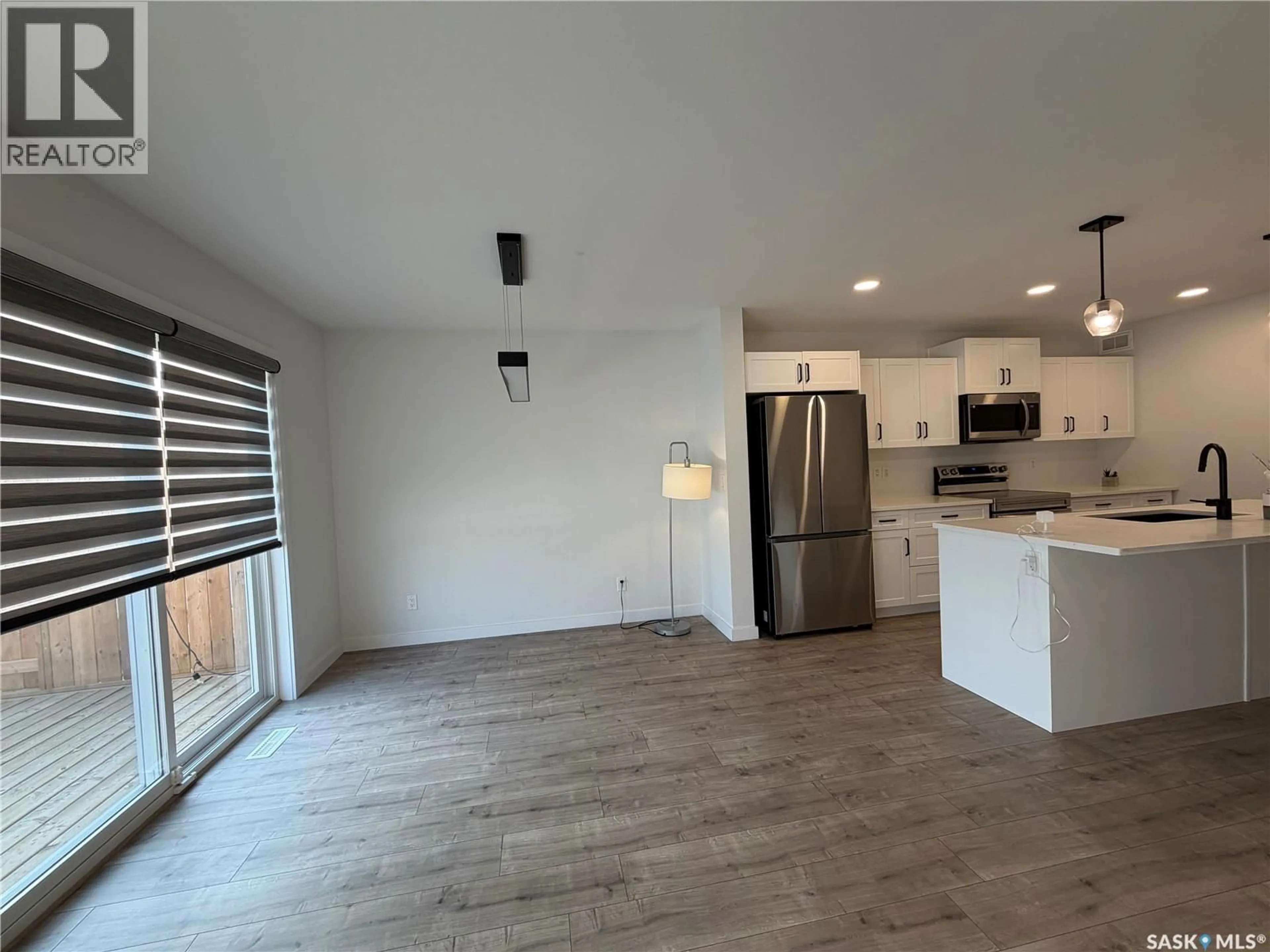 Open concept kitchen, wood/laminate floor for 114 COWESSESS ROAD, Saskatoon Saskatchewan S7V1S3
