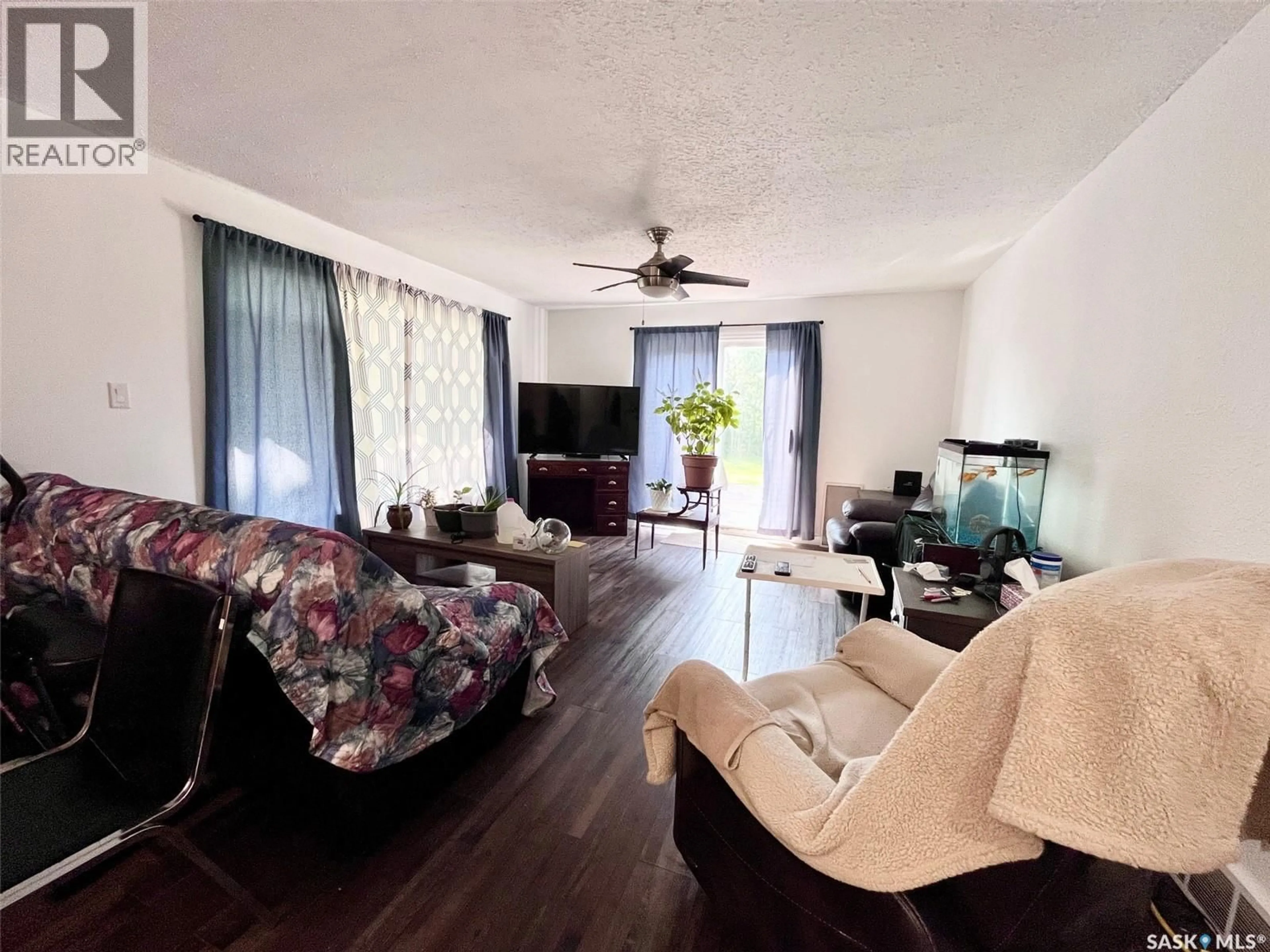 Living room with furniture, wood/laminate floor for 120 HANSON LAKE ROAD, Smeaton Saskatchewan S0J2J0