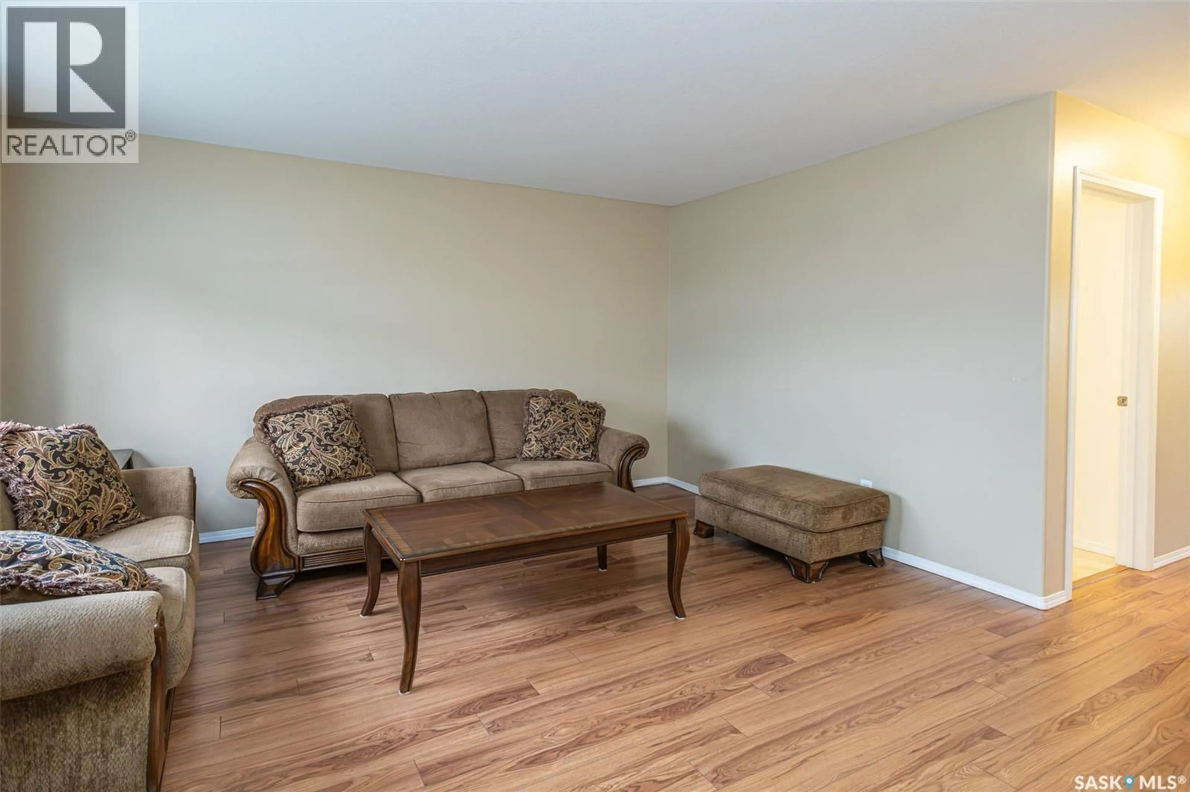 Living room with furniture, wood/laminate floor for 156 203 HEROLD TERRACE, Saskatoon Saskatchewan S7V1H8