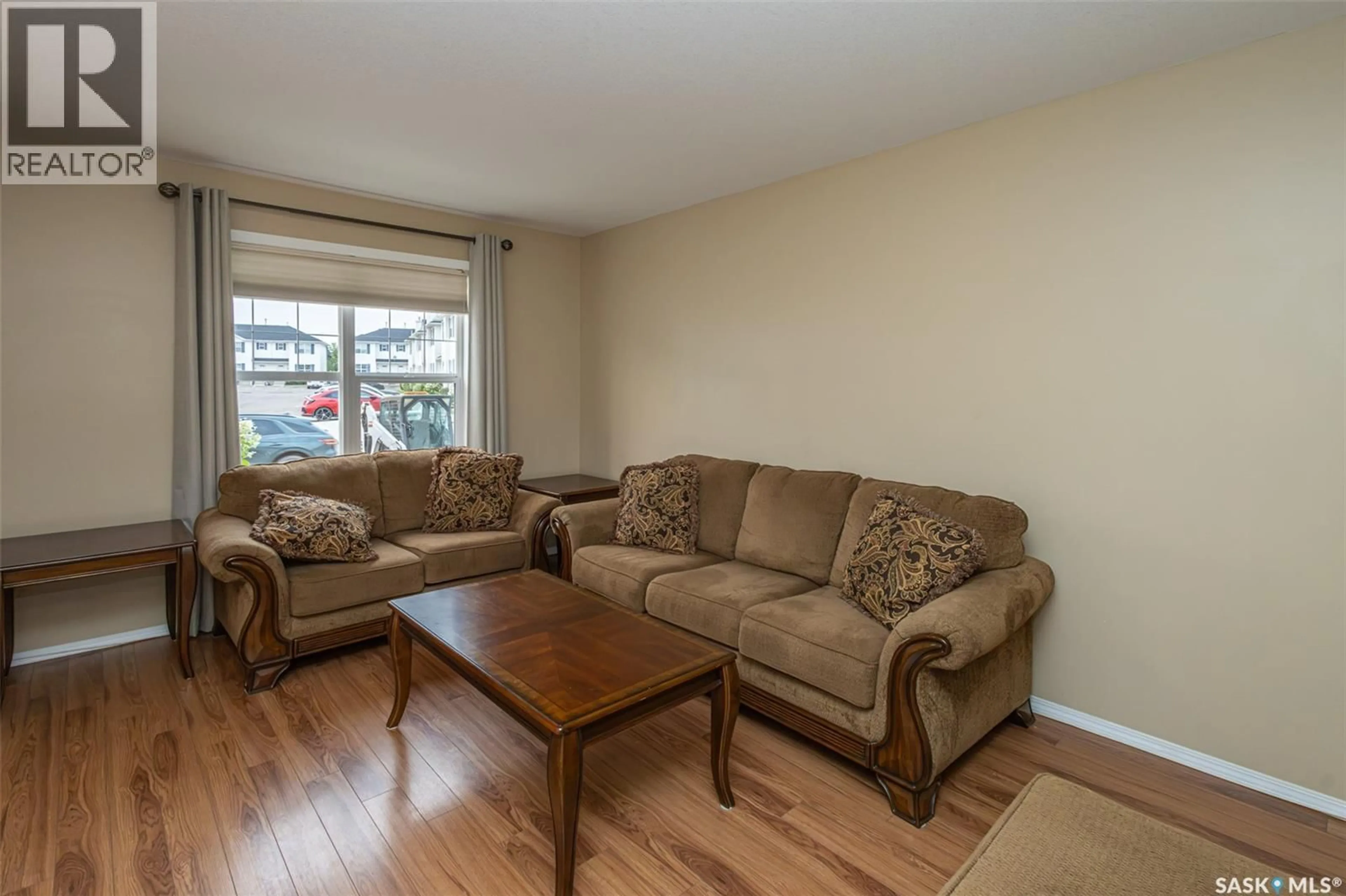Living room with furniture, wood/laminate floor for 156 203 HEROLD TERRACE, Saskatoon Saskatchewan S7V1H8