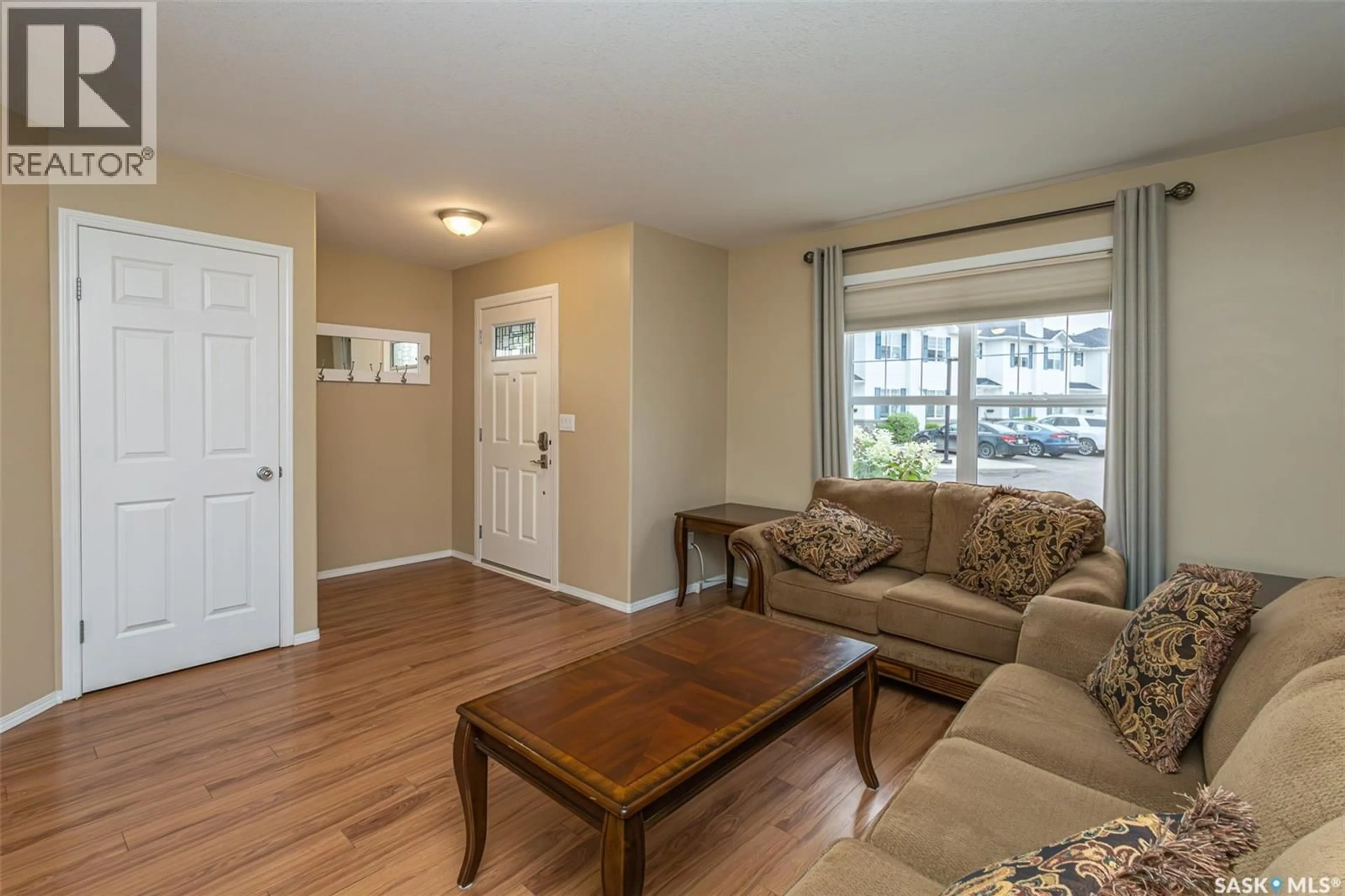 Living room with furniture, wood/laminate floor for 156 203 HEROLD TERRACE, Saskatoon Saskatchewan S7V1H8