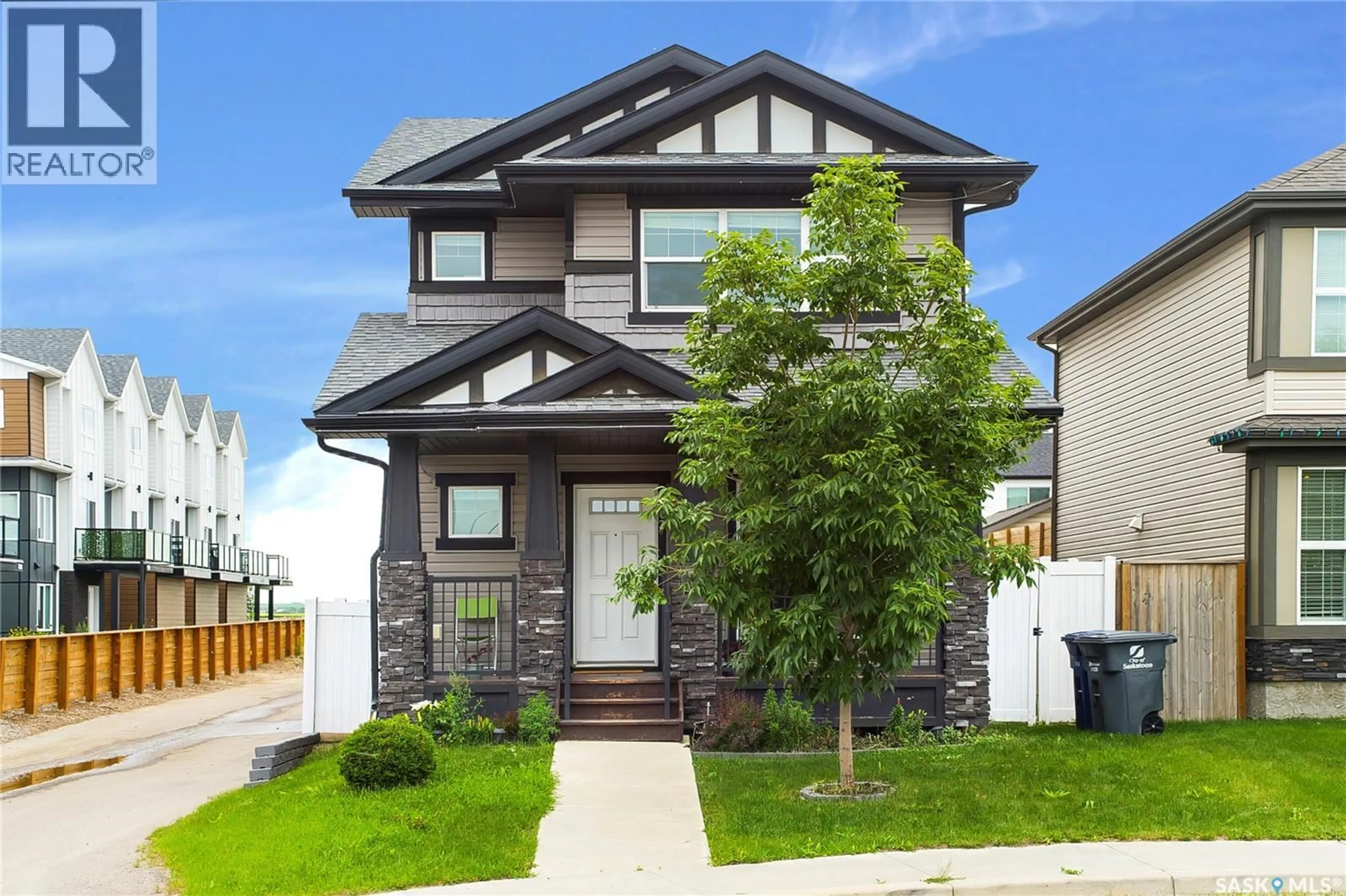 Home with vinyl exterior material, street for 303 DELAINEY MANOR, Saskatoon Saskatchewan S7V0N4