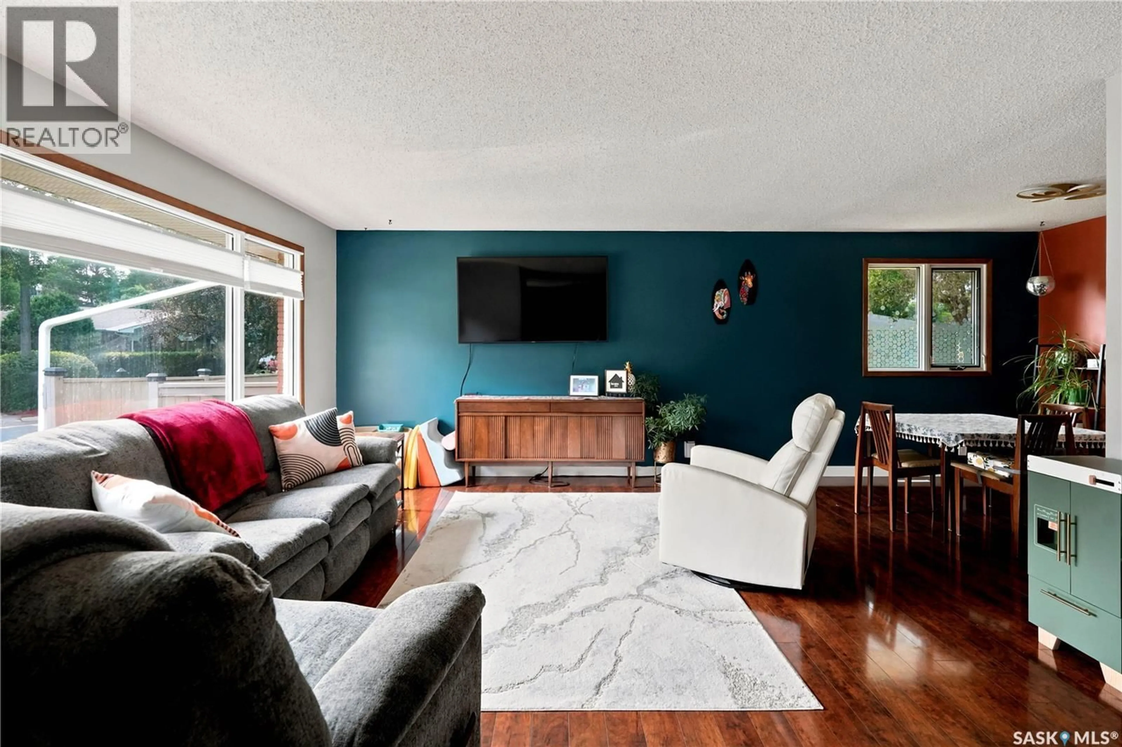 Living room with furniture, wood/laminate floor for 144 ORCHARD CRESCENT, Regina Saskatchewan S4S5B6