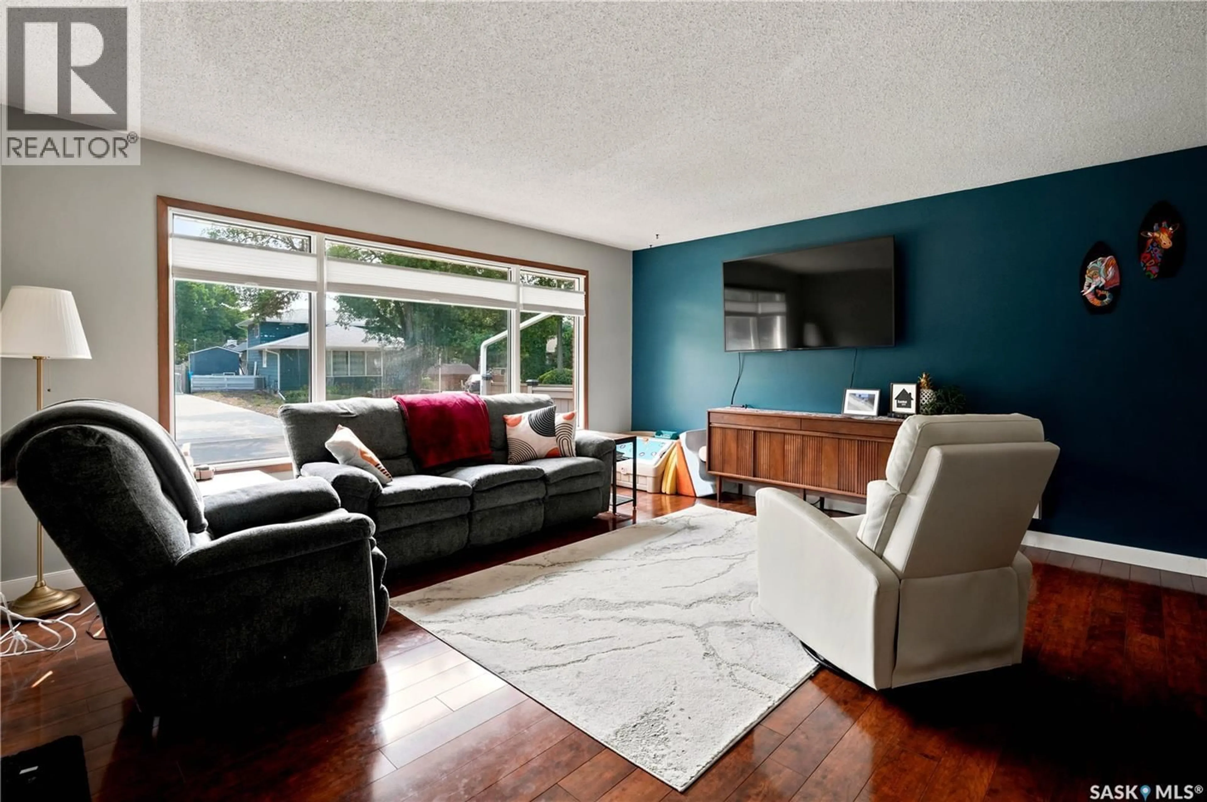 Living room with furniture, wood/laminate floor for 144 ORCHARD CRESCENT, Regina Saskatchewan S4S5B6