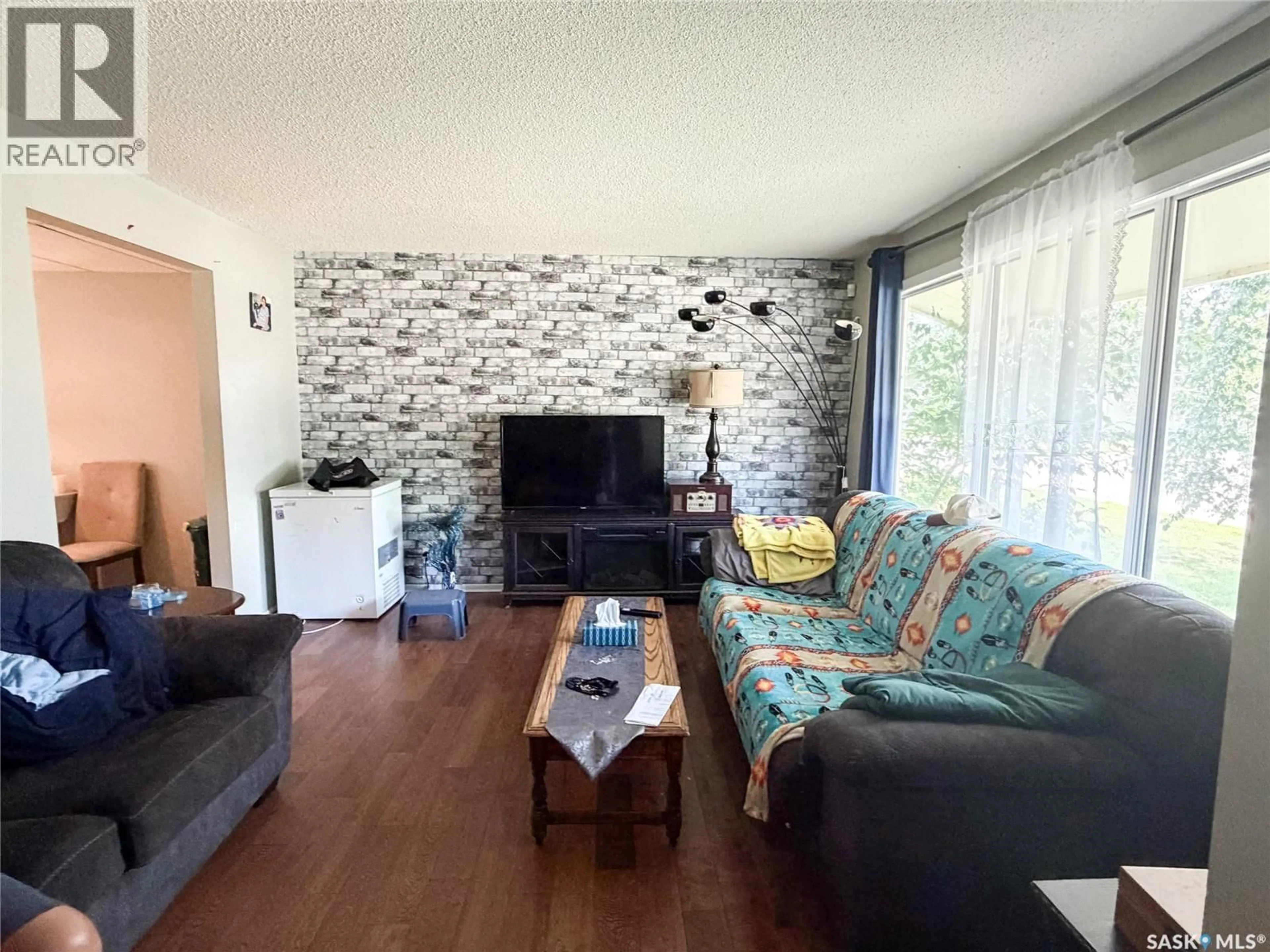 Living room with furniture, wood/laminate floor for 518 1ST STREET, Meadow Lake Saskatchewan S9X1E9