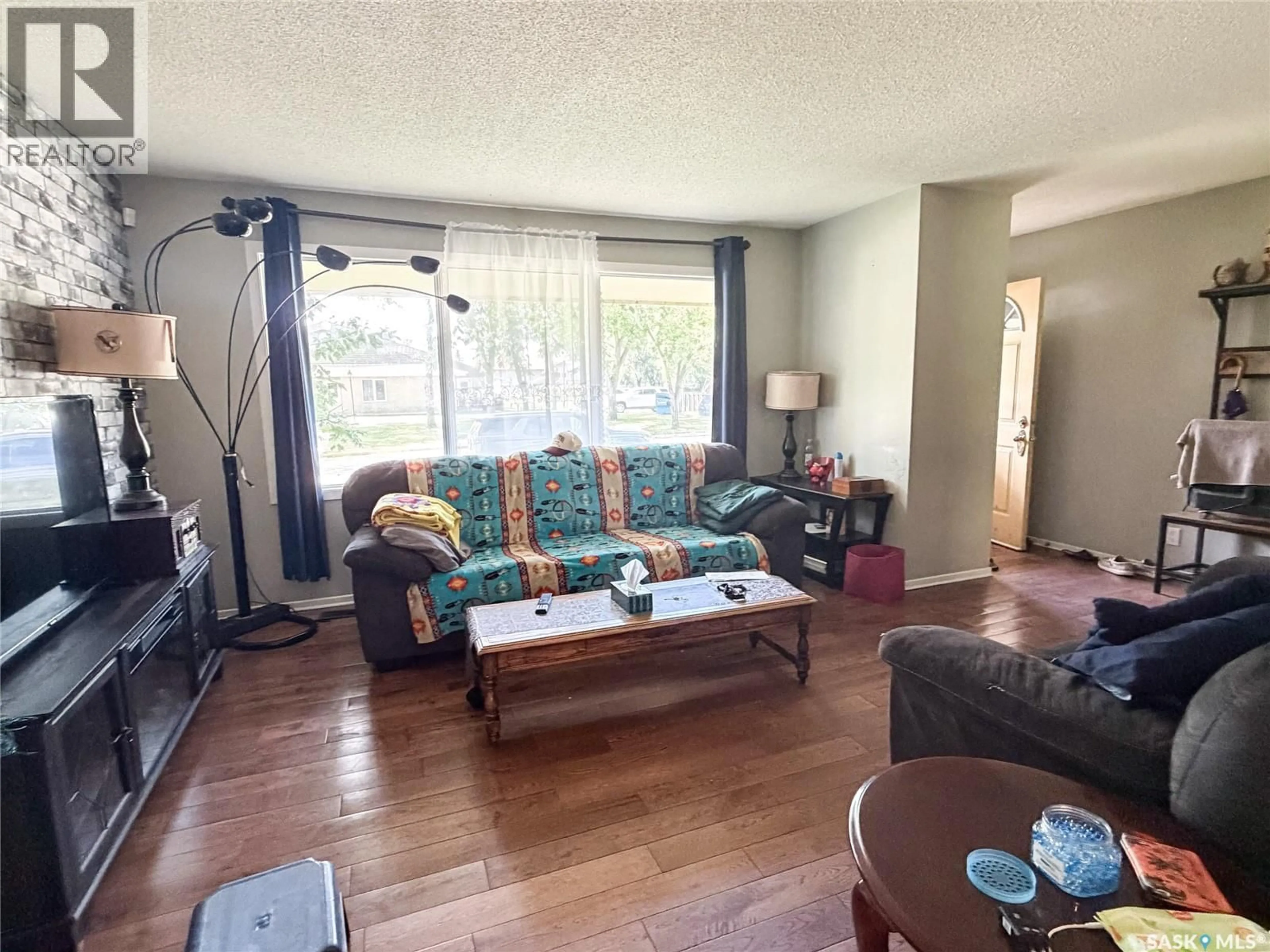 Living room with furniture, wood/laminate floor for 518 1ST STREET, Meadow Lake Saskatchewan S9X1E9