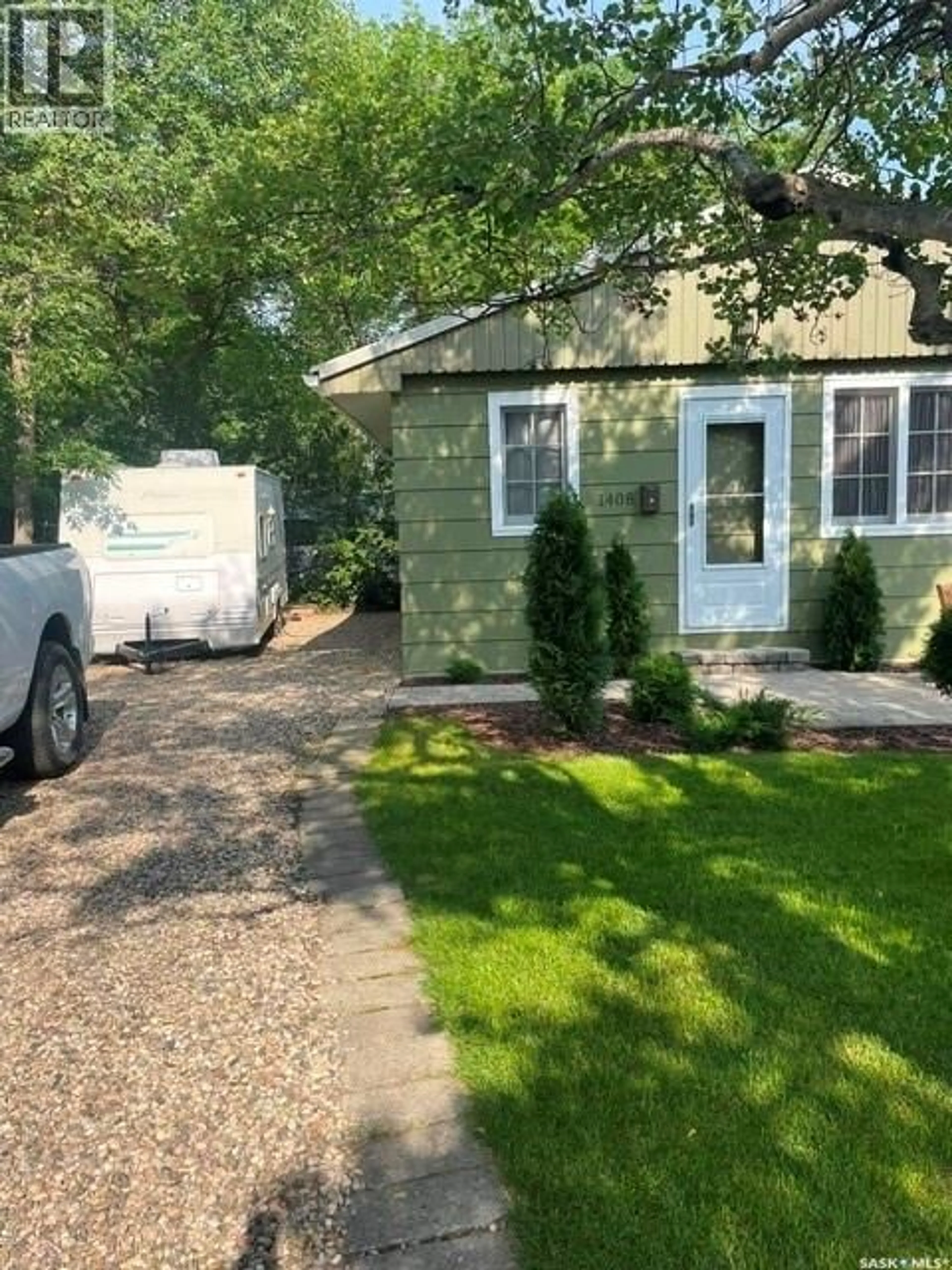 Home with vinyl exterior material, street for 1408 6TH AVENUE, Regina Beach Saskatchewan S0G4C0