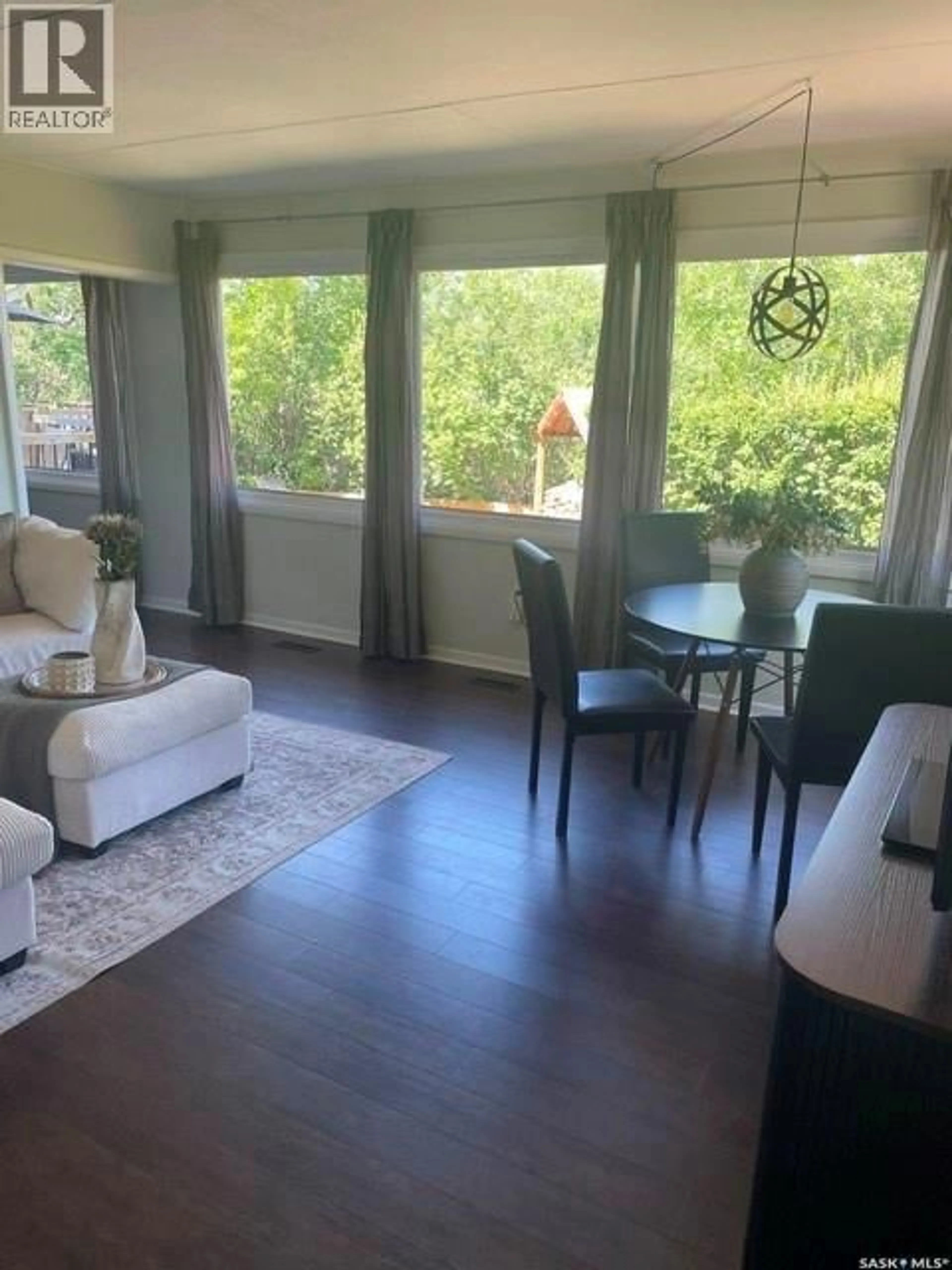 Living room with furniture, wood/laminate floor for 1408 6TH AVENUE, Regina Beach Saskatchewan S0G4C0