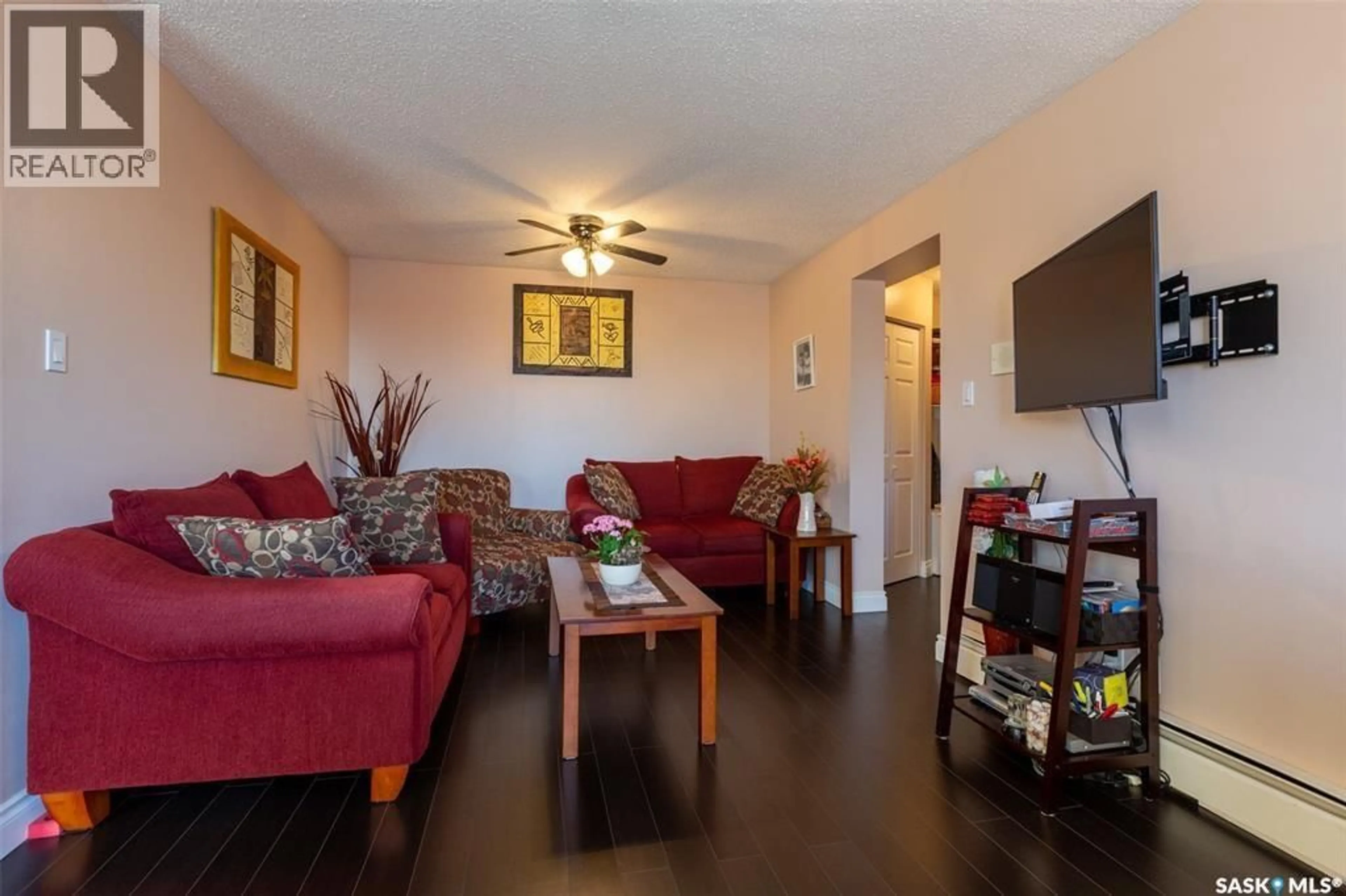 Living room with furniture, wood/laminate floor for 34 - 302 NOLLET AVENUE, Regina Saskatchewan S4T7J8
