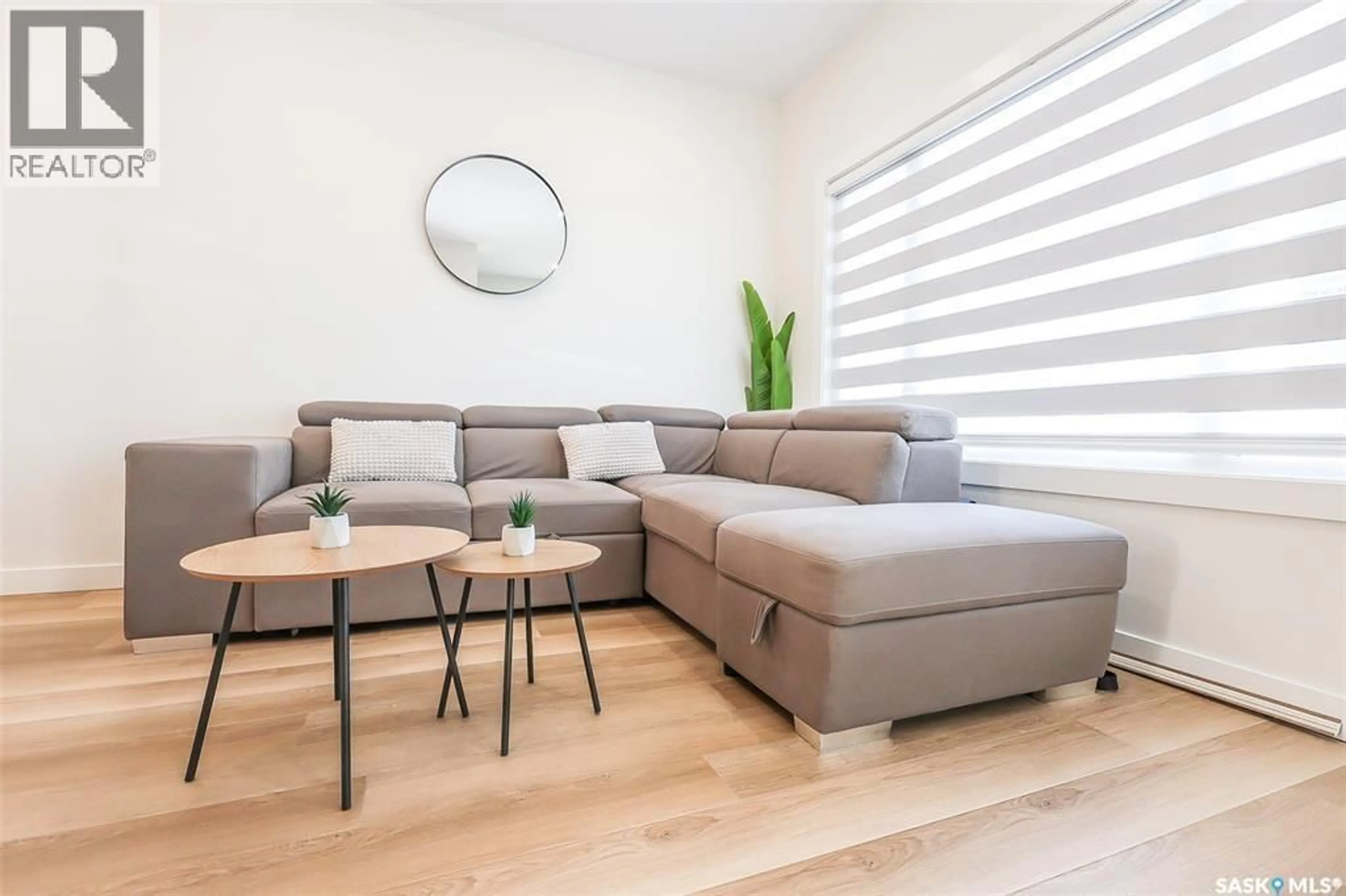 Living room with furniture, wood/laminate floor for 1513 RICHARDSON ROAD, Saskatoon Saskatchewan S7M0W9