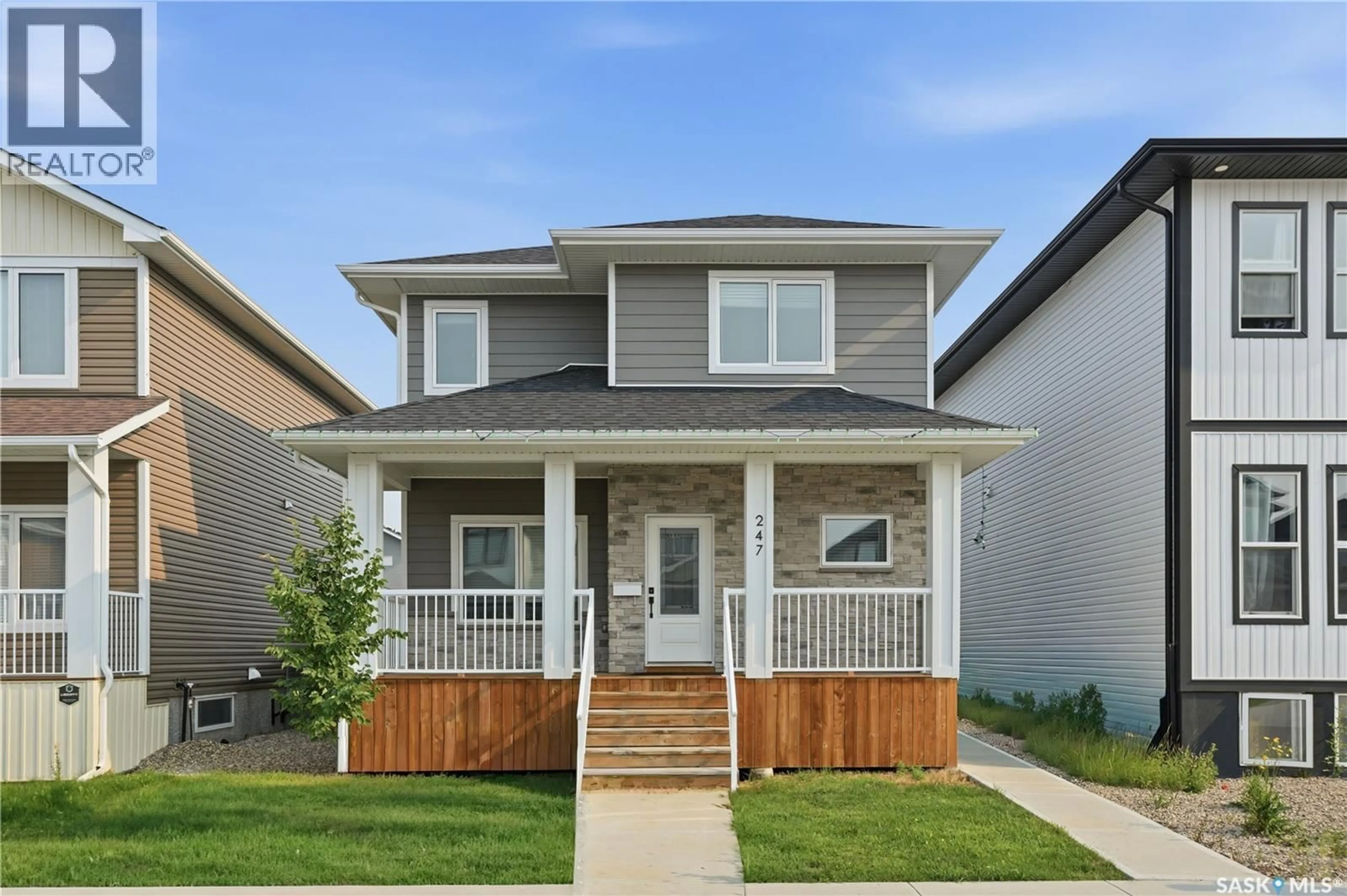 Home with vinyl exterior material, street for 247 THAKUR STREET, Saskatoon Saskatchewan S7W1C5