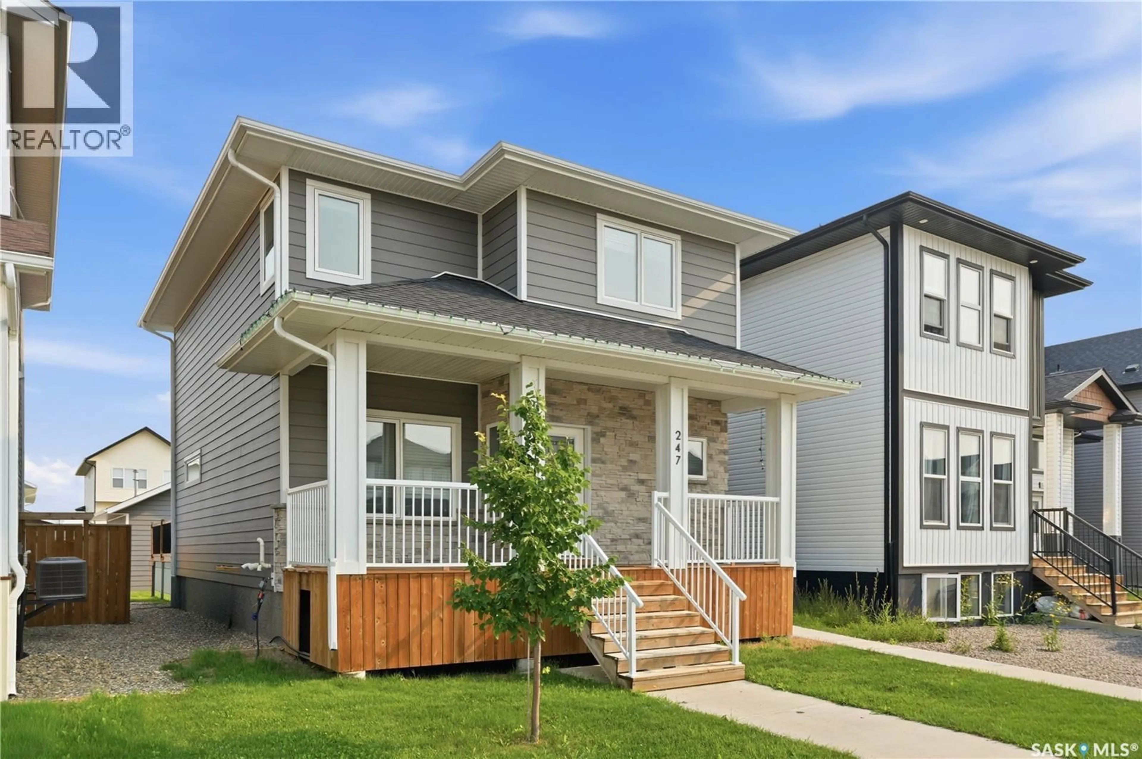 Home with vinyl exterior material, street for 247 THAKUR STREET, Saskatoon Saskatchewan S7W1C5