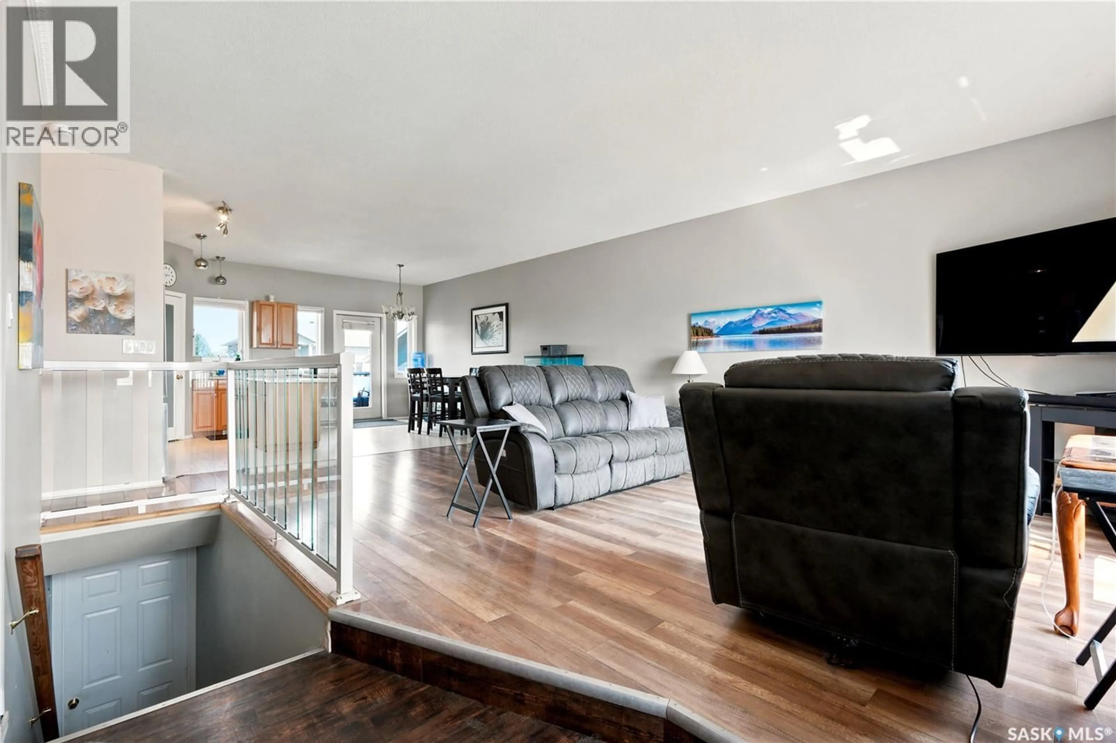 Living room with furniture, wood/laminate floor for 618 DEER COURT, Warman Saskatchewan S0K4S0