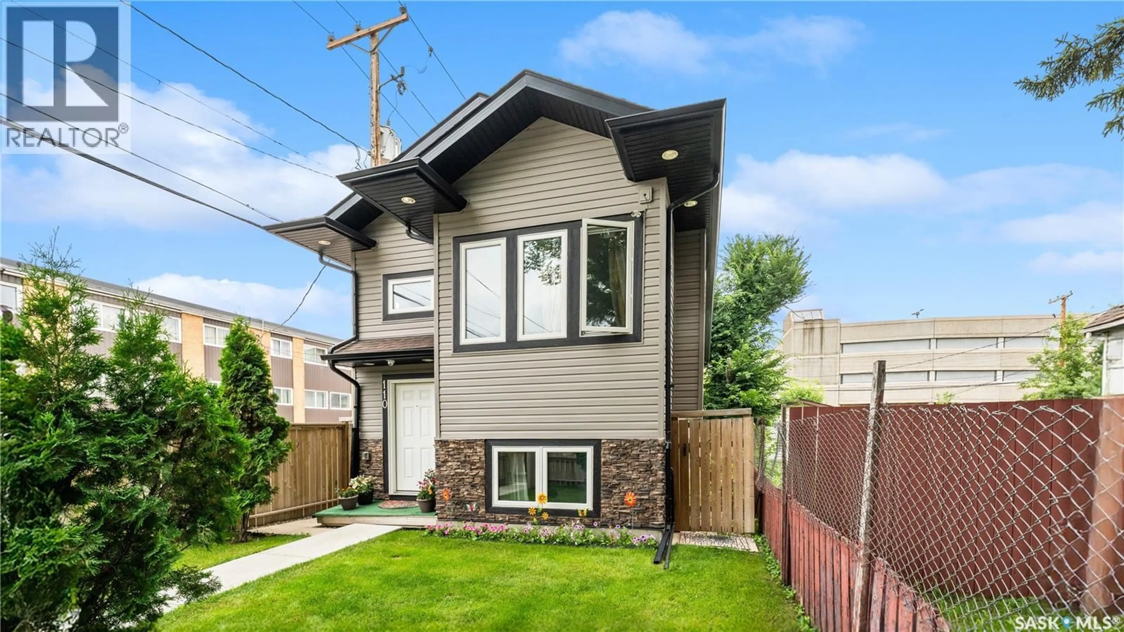 Home with vinyl exterior material, street for 110 S AVENUE S, Saskatoon Saskatchewan S7M2Z6