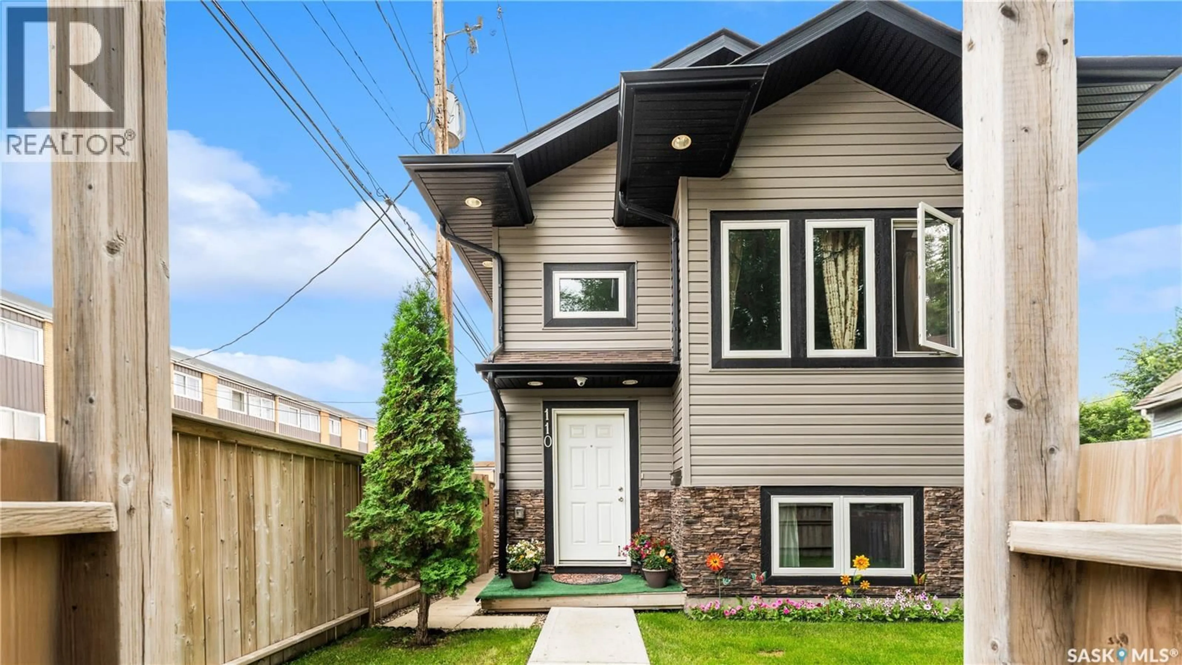 Home with vinyl exterior material, street for 110 S AVENUE S, Saskatoon Saskatchewan S7M2Z6