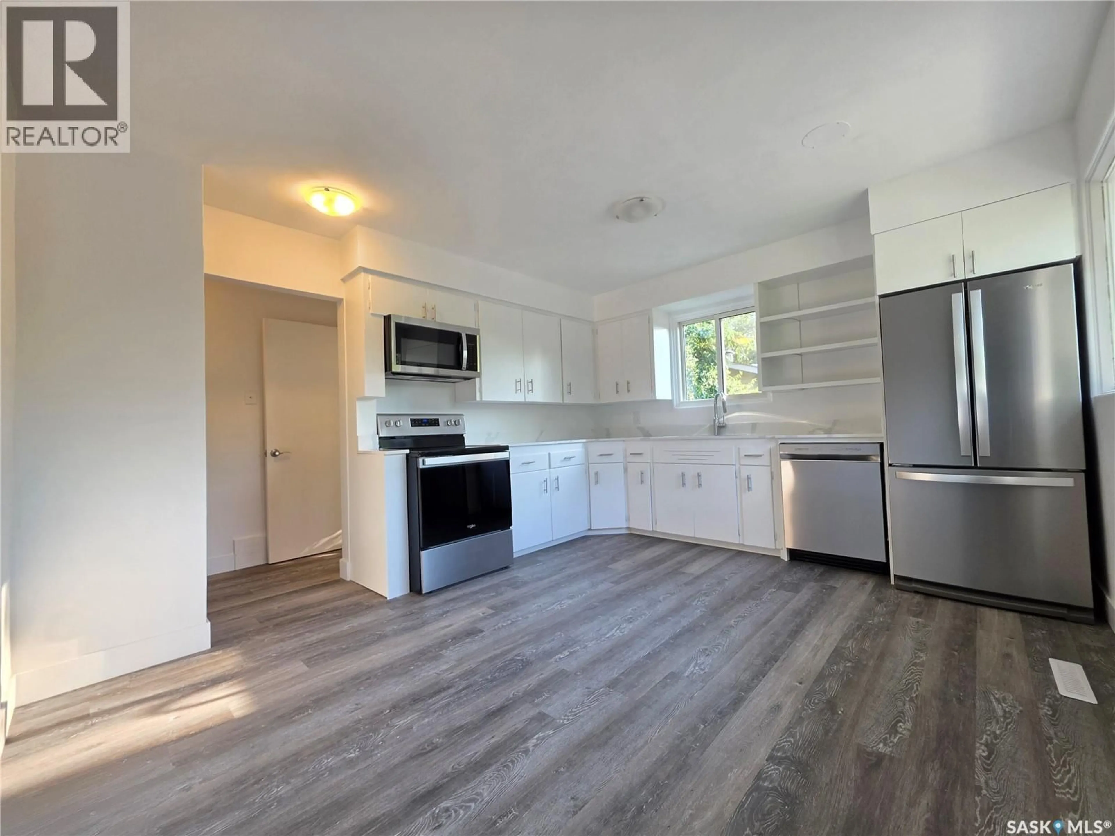 Open concept kitchen, wood/laminate floor for 1422 CRAWFORD AVENUE, Swift Current Saskatchewan S9H1E9