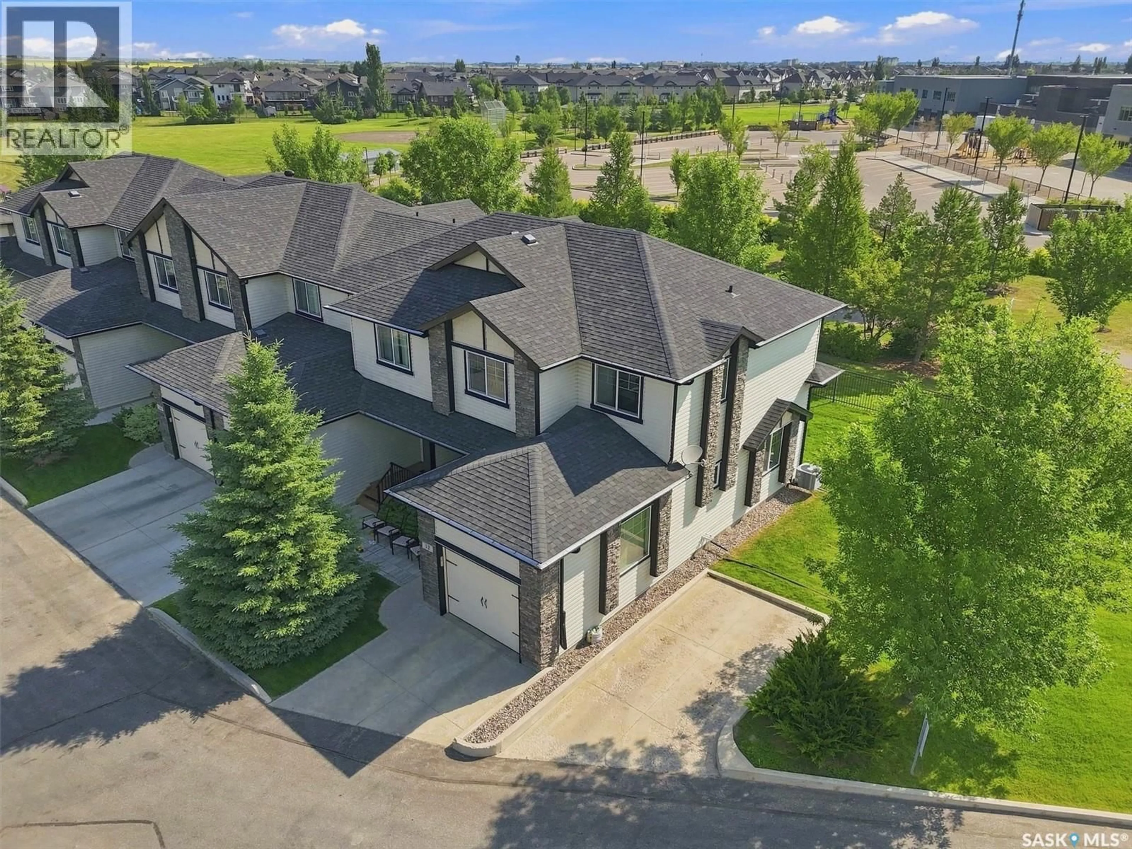 A pic from outside/outdoor area/front of a property/back of a property/a pic from drone, mountain view for 32 215 HAMPTON GREEN, Saskatoon Saskatchewan S7R0G7