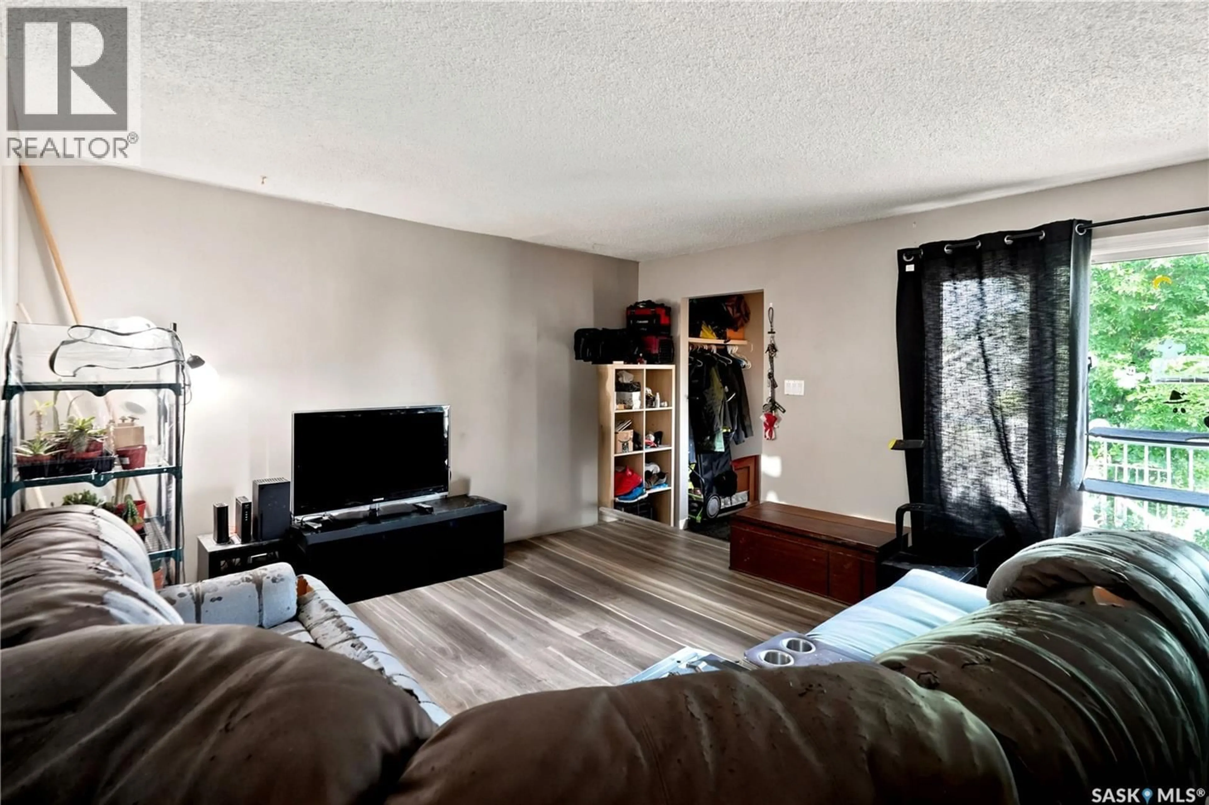 Living room with furniture, wood/laminate floor for 2232 MCARA STREET, Regina Saskatchewan S4N2W1