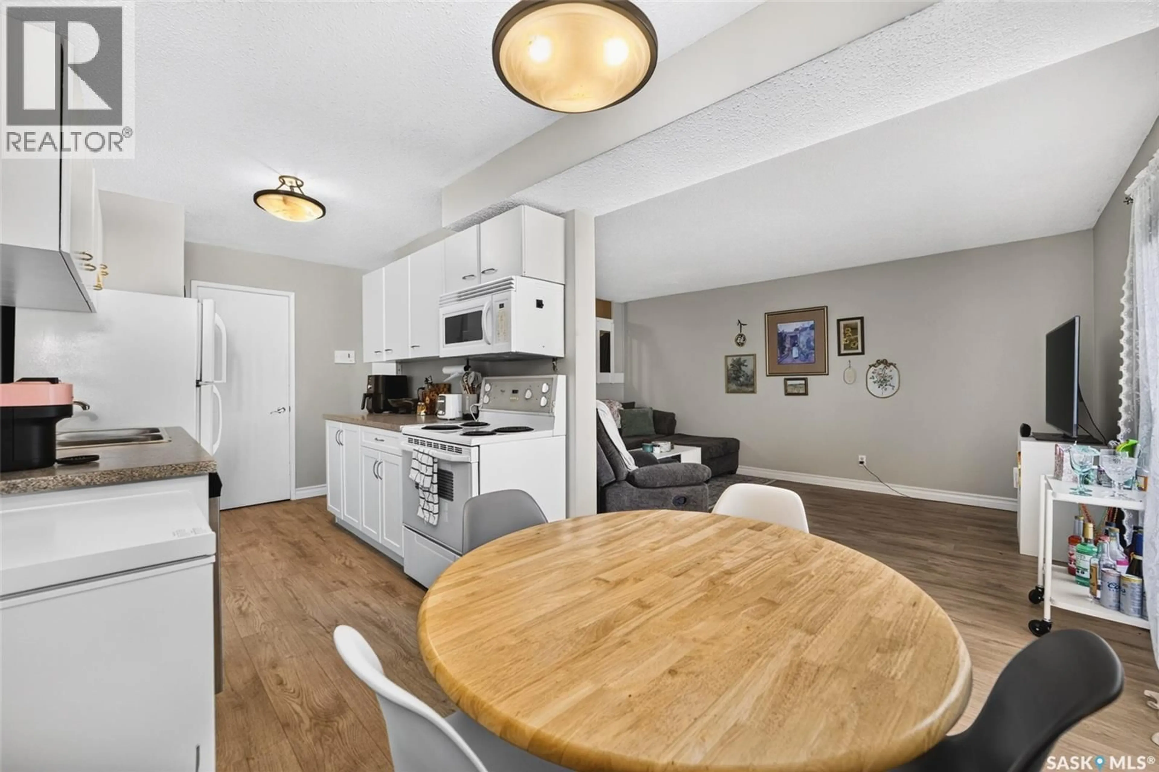 Open concept kitchen, wood/laminate floor for 4216 CASTLE ROAD, Regina Saskatchewan S4S4W1