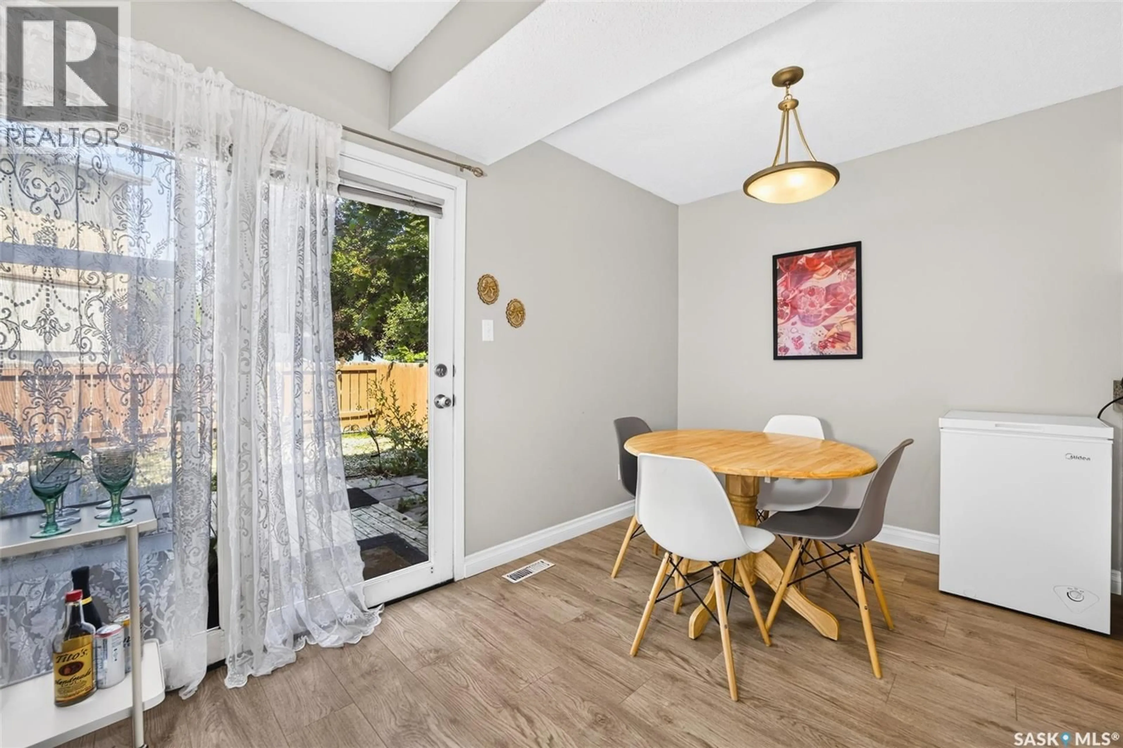 Dining room, wood/laminate floor for 4216 CASTLE ROAD, Regina Saskatchewan S4S4W1