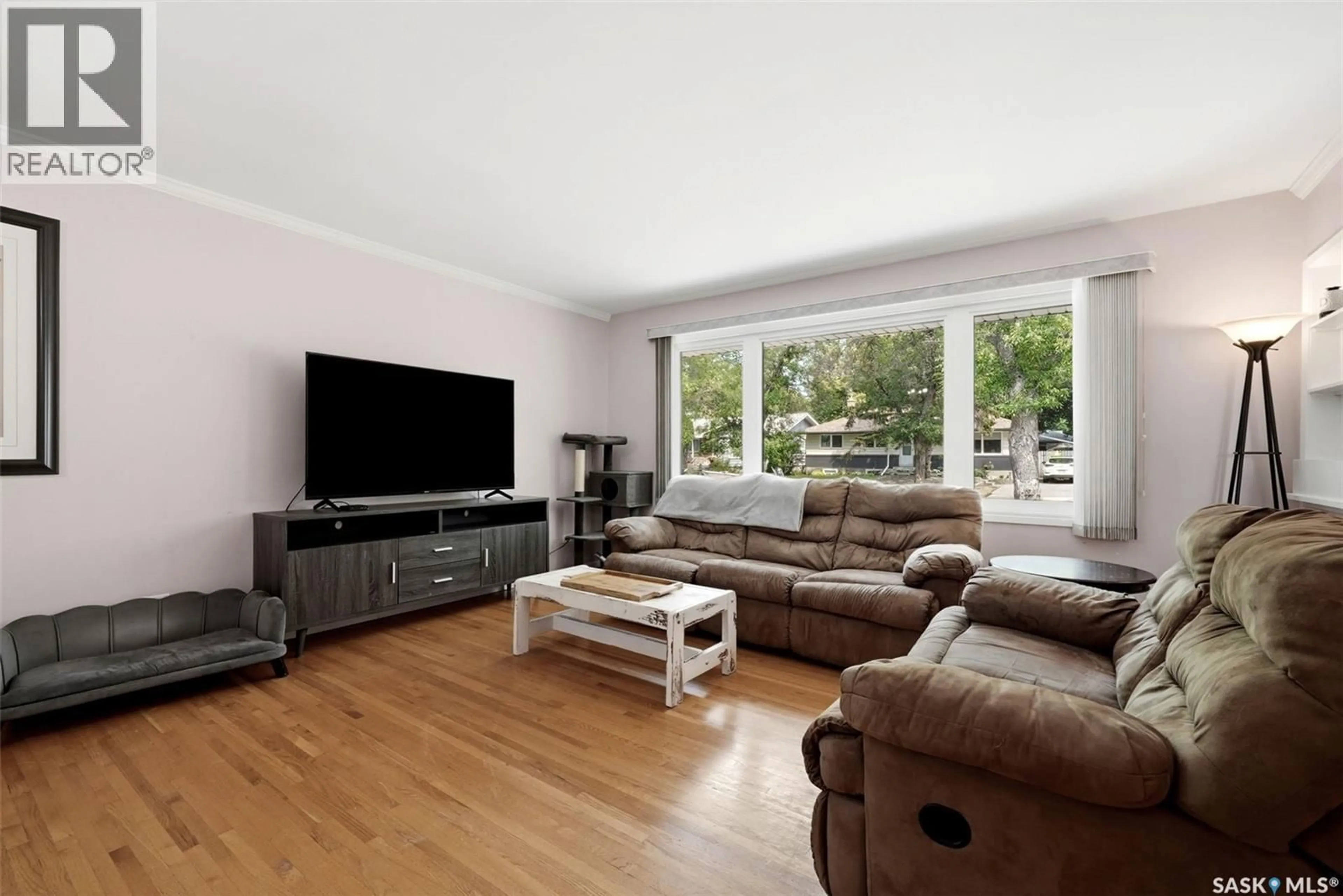 Living room with furniture, wood/laminate floor for 14 BELL STREET, Regina Saskatchewan S4S4B6