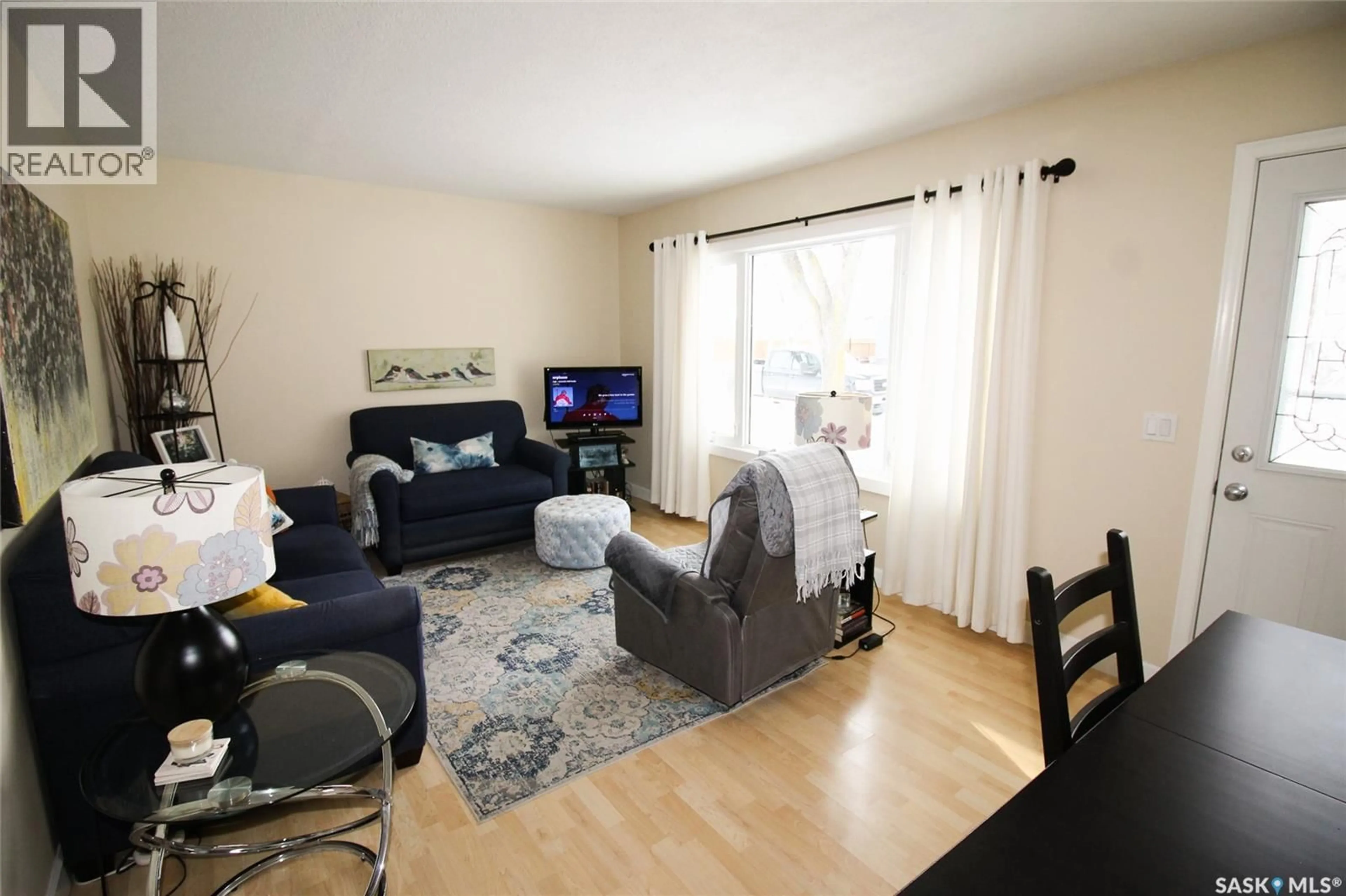 Living room with furniture, wood/laminate floor for 644 1ST STREET, Shaunavon Saskatchewan S0N2M0
