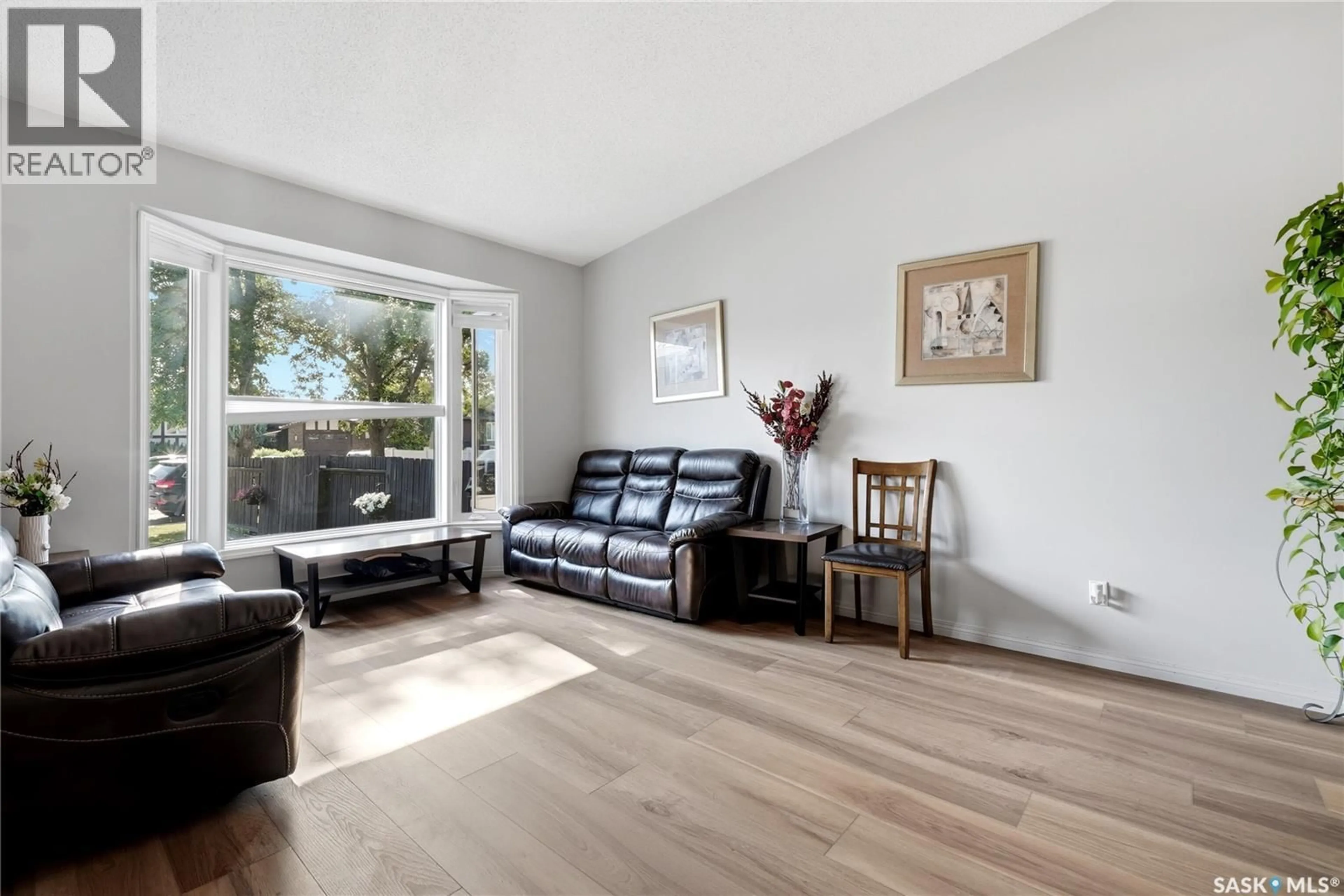 Living room with furniture, wood/laminate floor for 1054 BAYDA CRESCENT, Regina Saskatchewan S4N6Y6