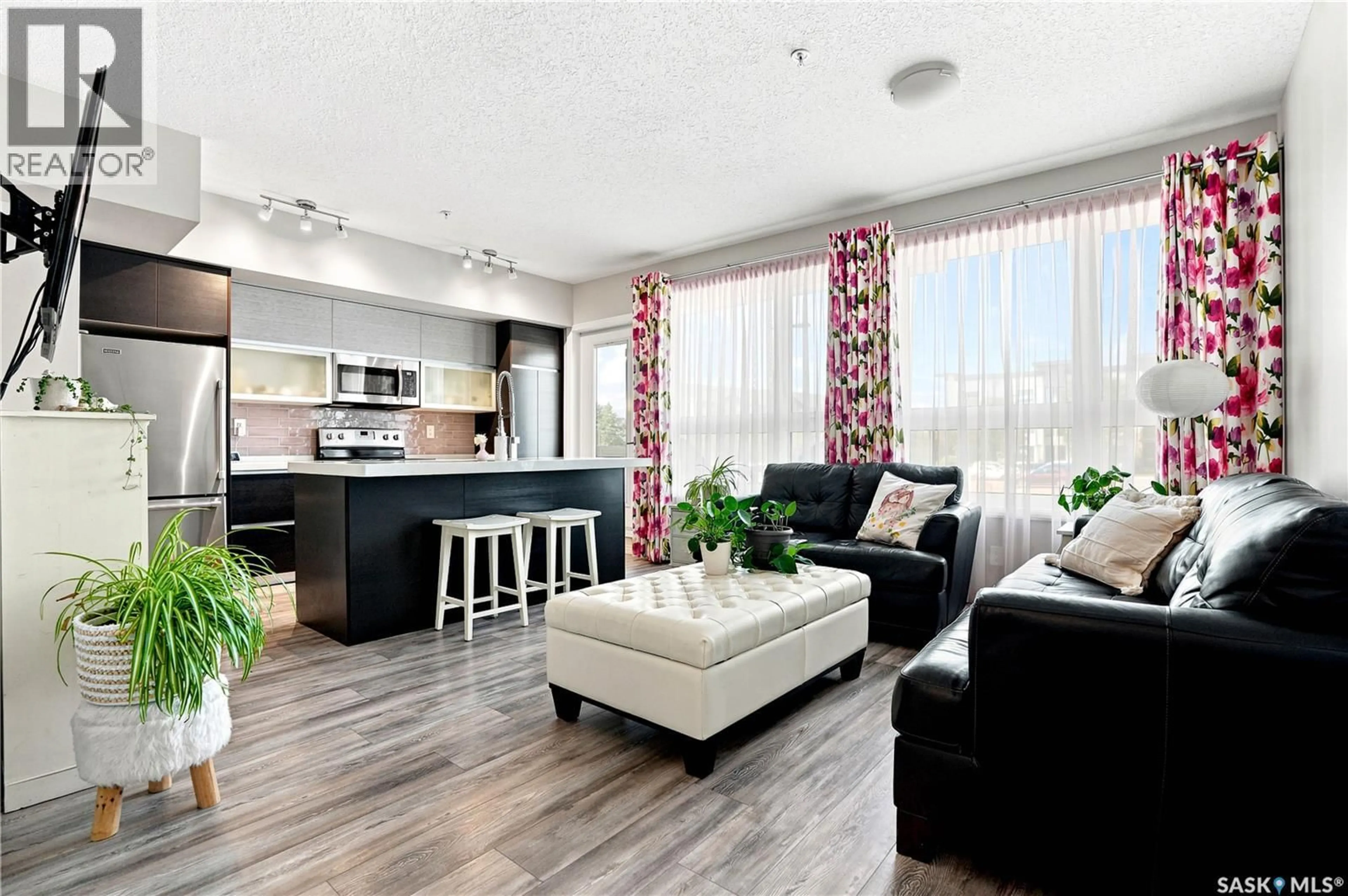 Living room with furniture, wood/laminate floor for 108 235 EVERGREEN SQUARE, Saskatoon Saskatchewan S7W0T9
