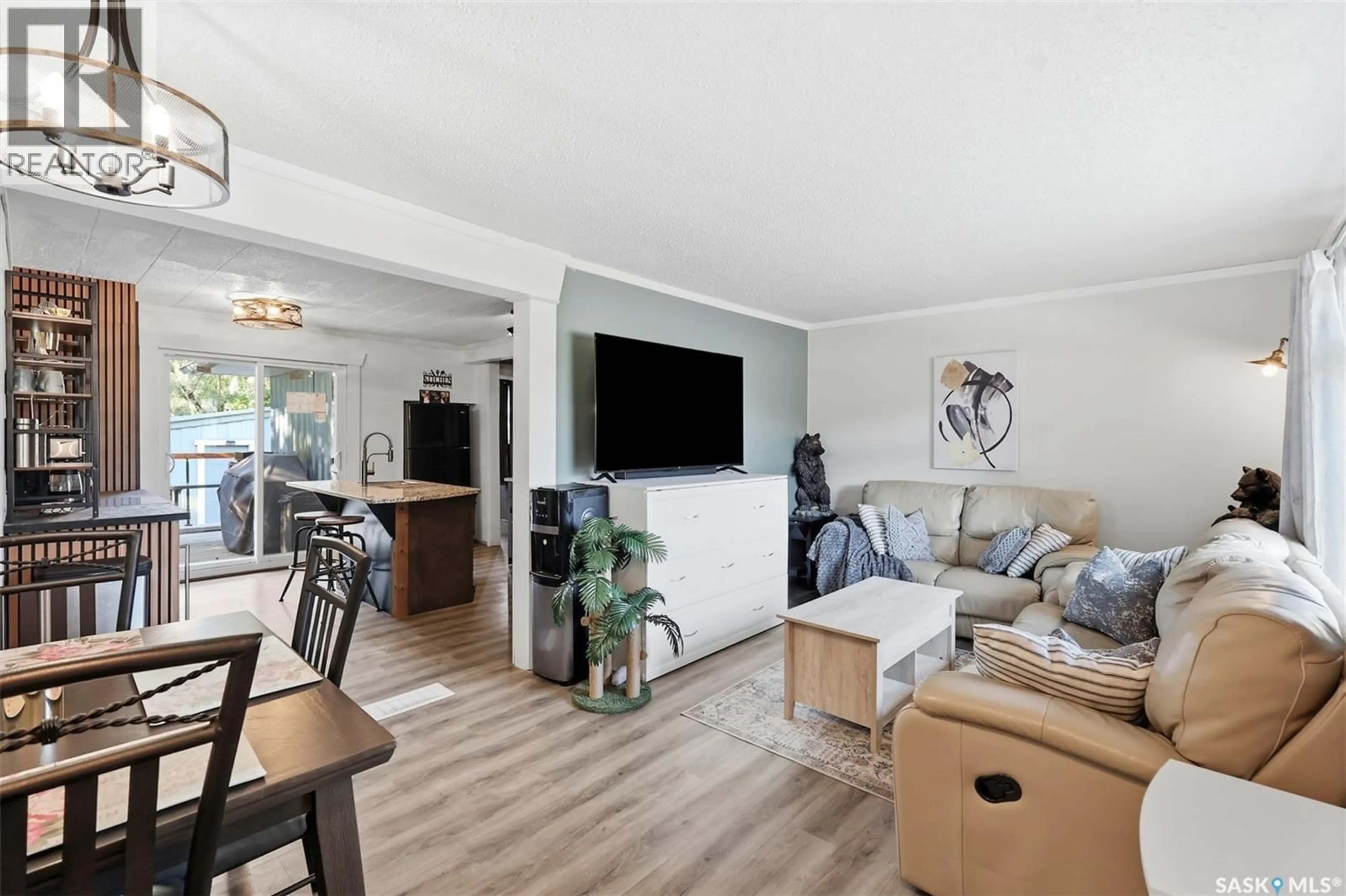 Living room with furniture, wood/laminate floor for 116 PRINCESS AVENUE, Hafford Saskatchewan S0J1A0