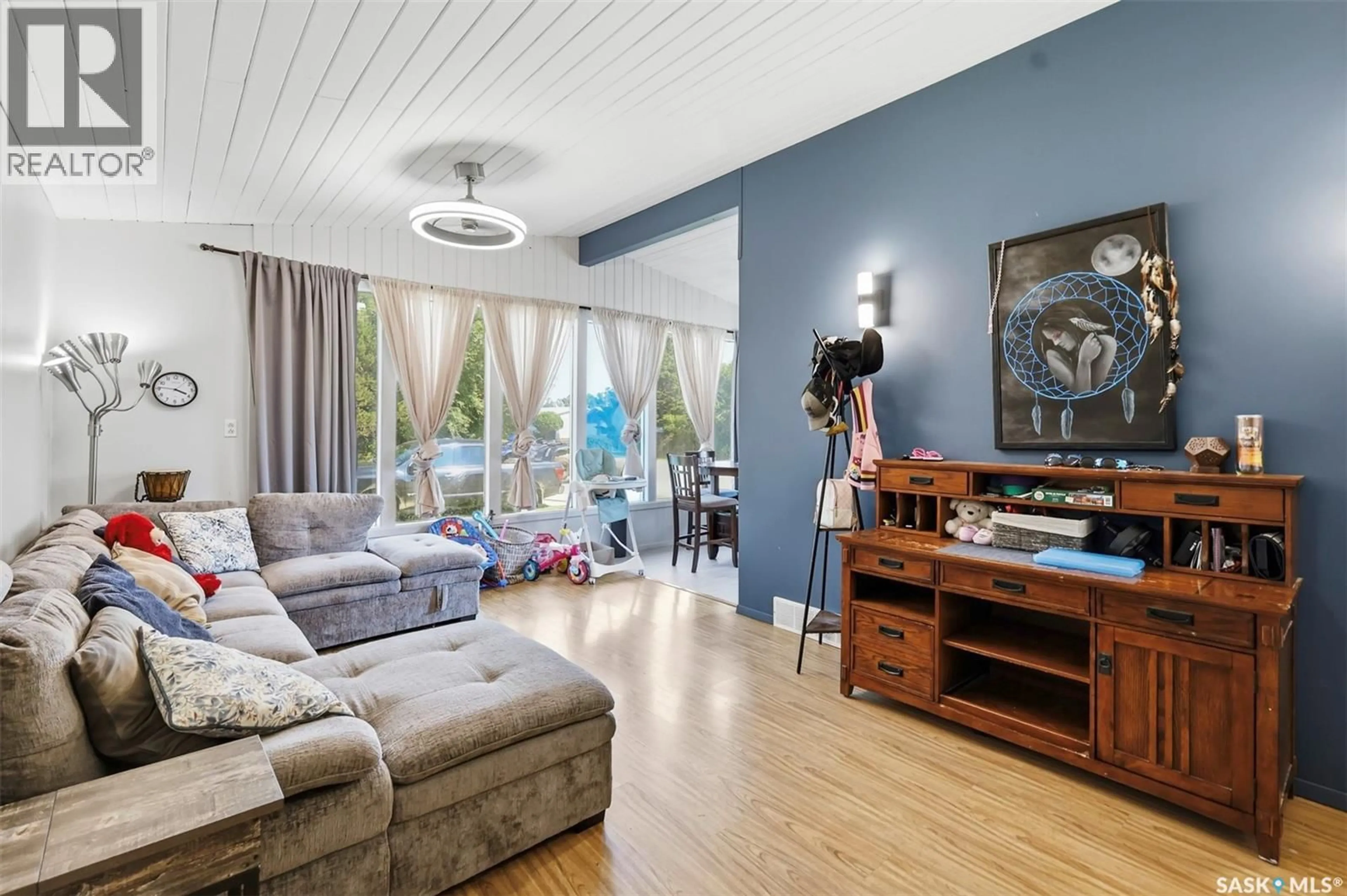 Living room with furniture, wood/laminate floor for 202 PRINCESS AVENUE, Hafford Saskatchewan S0J1A0