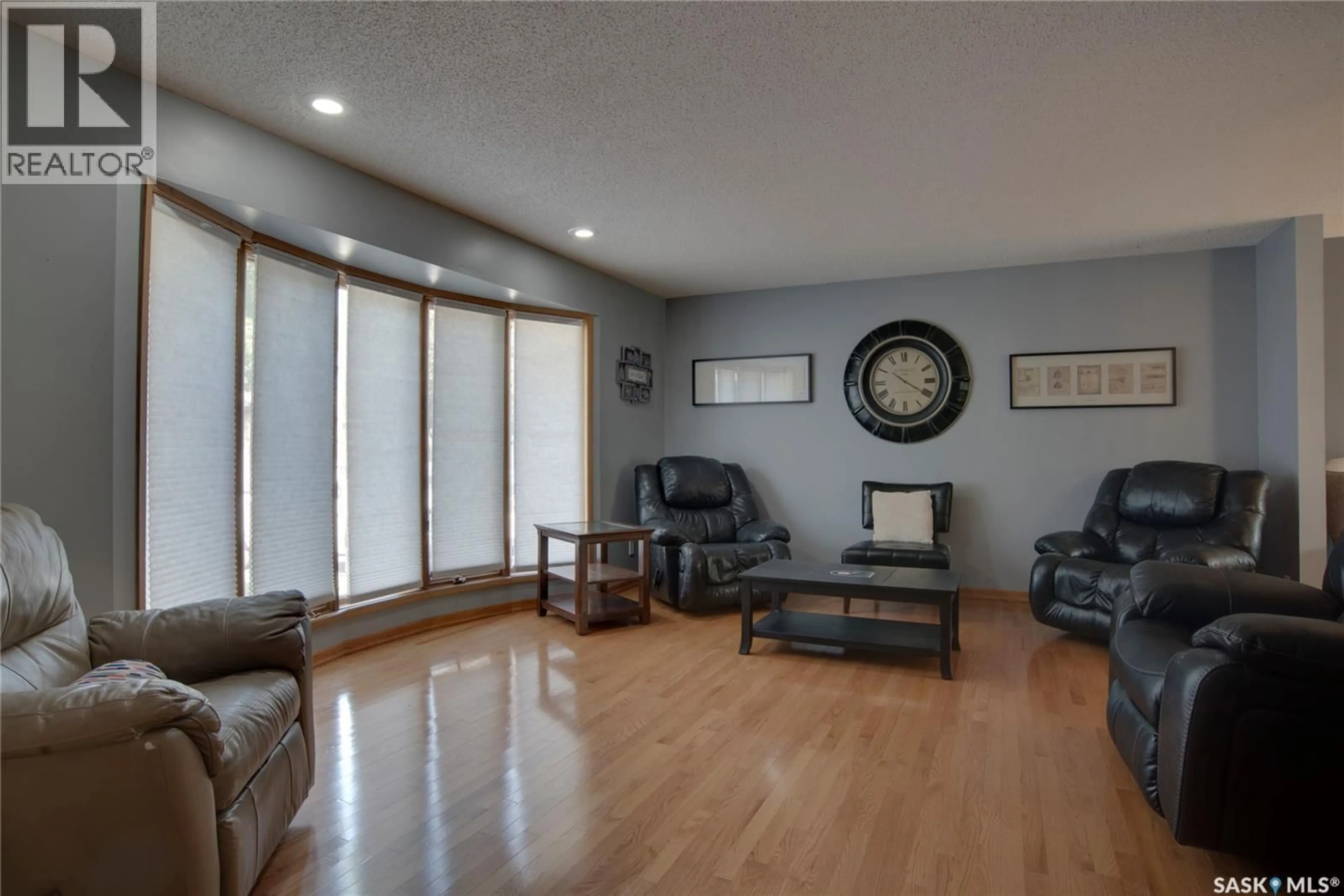 Living room with furniture, wood/laminate floor for 407 CHITEK CRESCENT, Saskatoon Saskatchewan S7K5C1