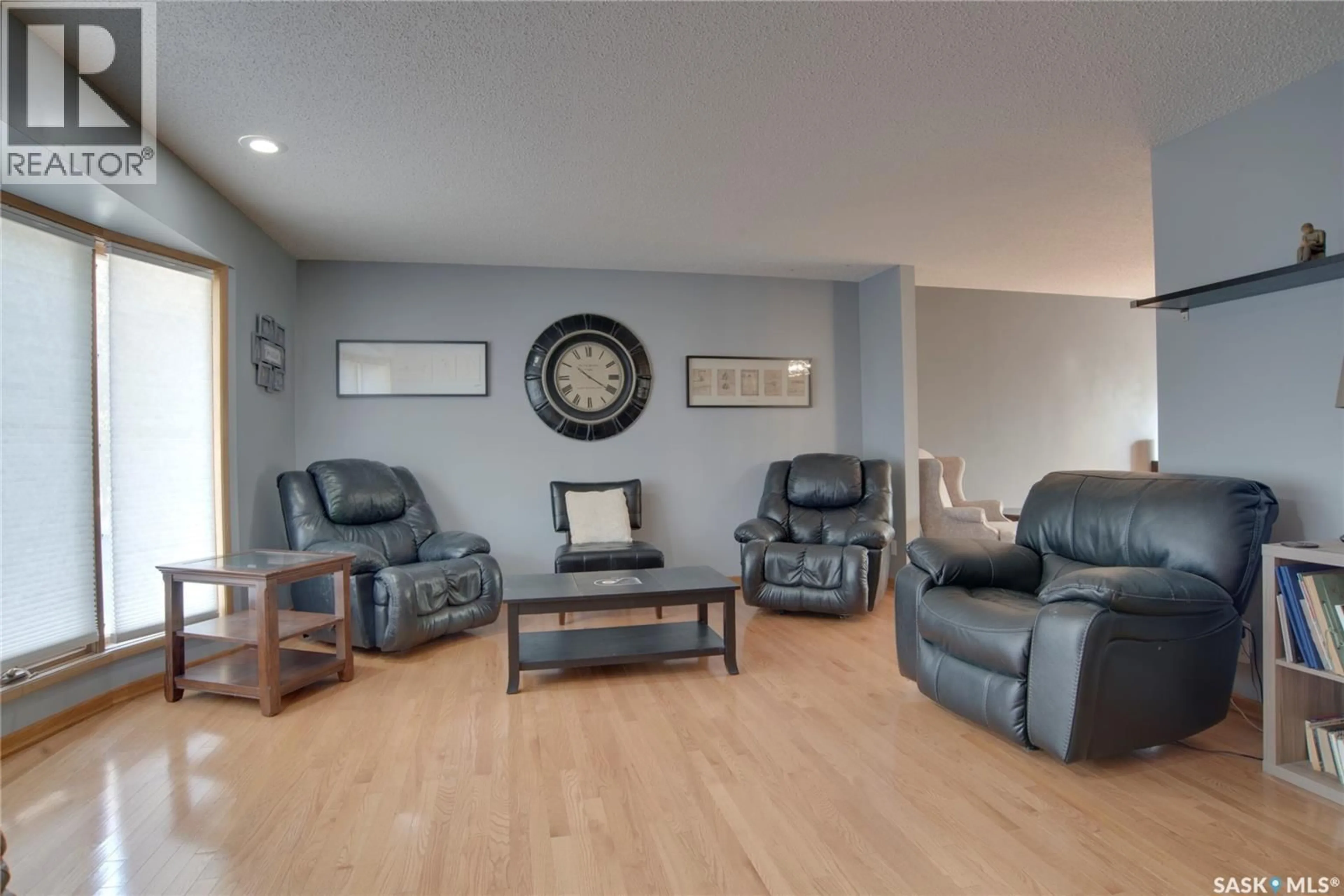 Living room with furniture, wood/laminate floor for 407 CHITEK CRESCENT, Saskatoon Saskatchewan S7K5C1