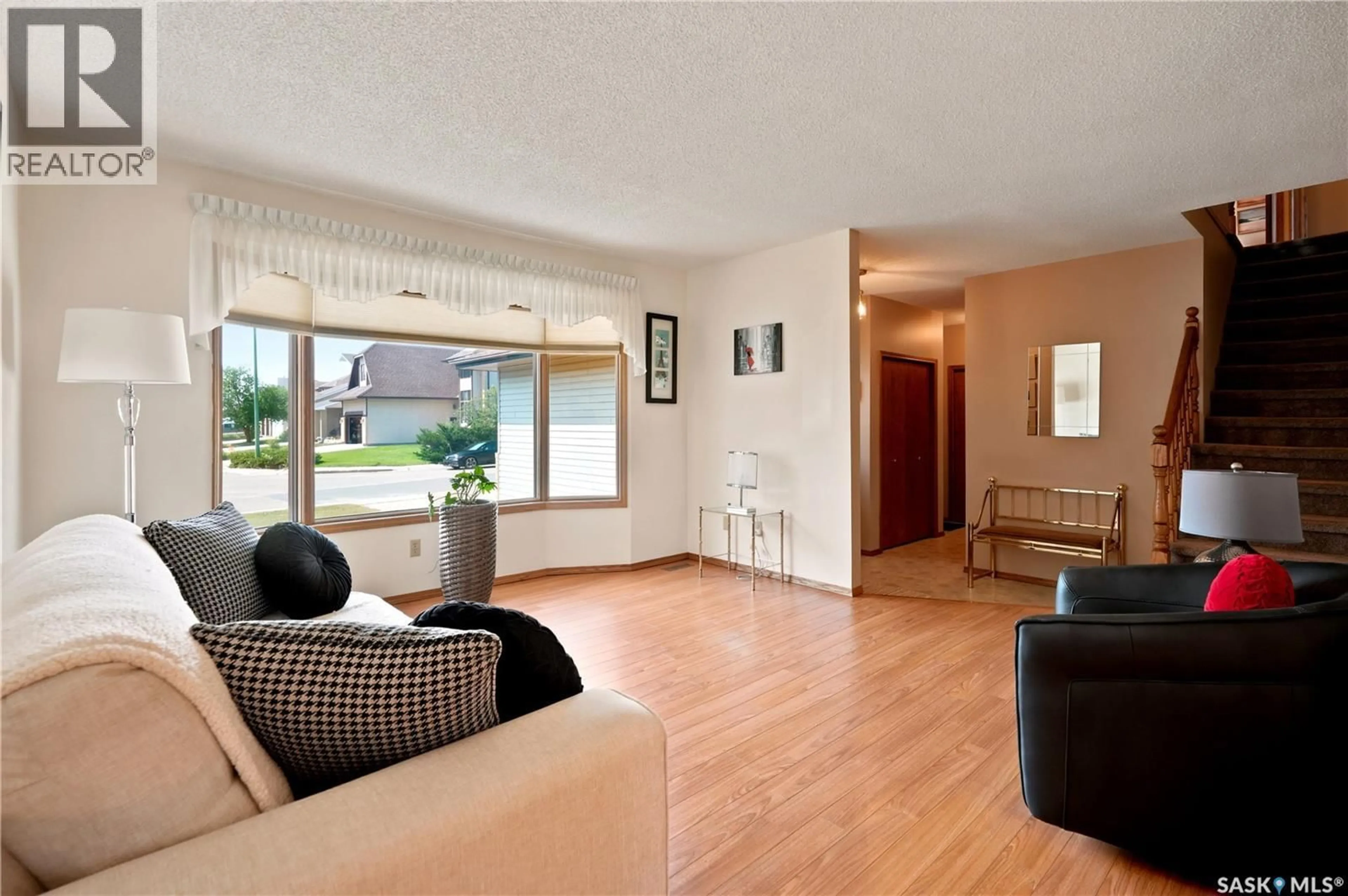 Living room with furniture, wood/laminate floor for 6112 BRUNSKILL PLACE, Regina Saskatchewan S4T7W7