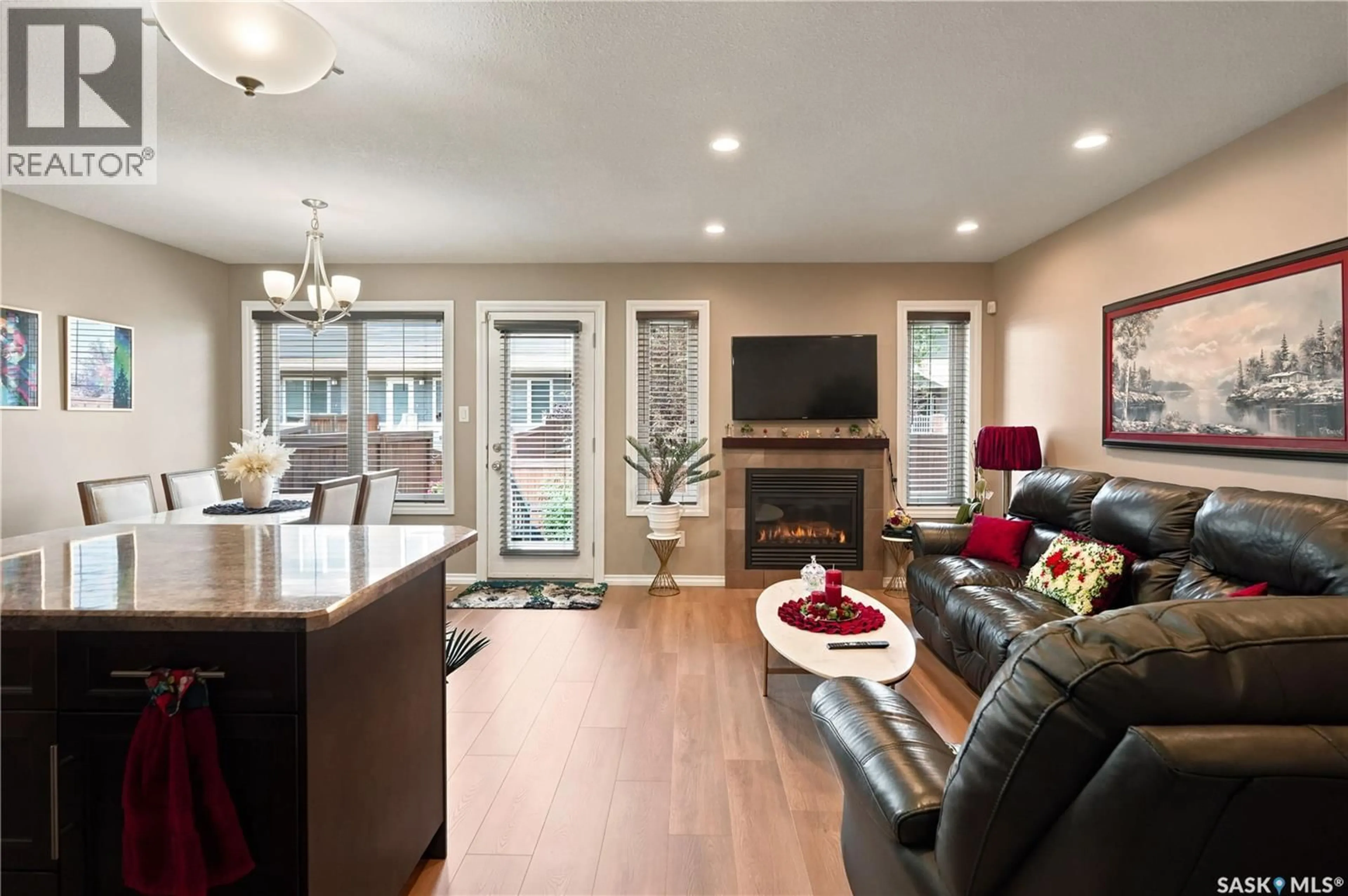 Living room with furniture, wood/laminate floor for 104 4100 SANDHILL CRESCENT, Regina Saskatchewan S4V3G9