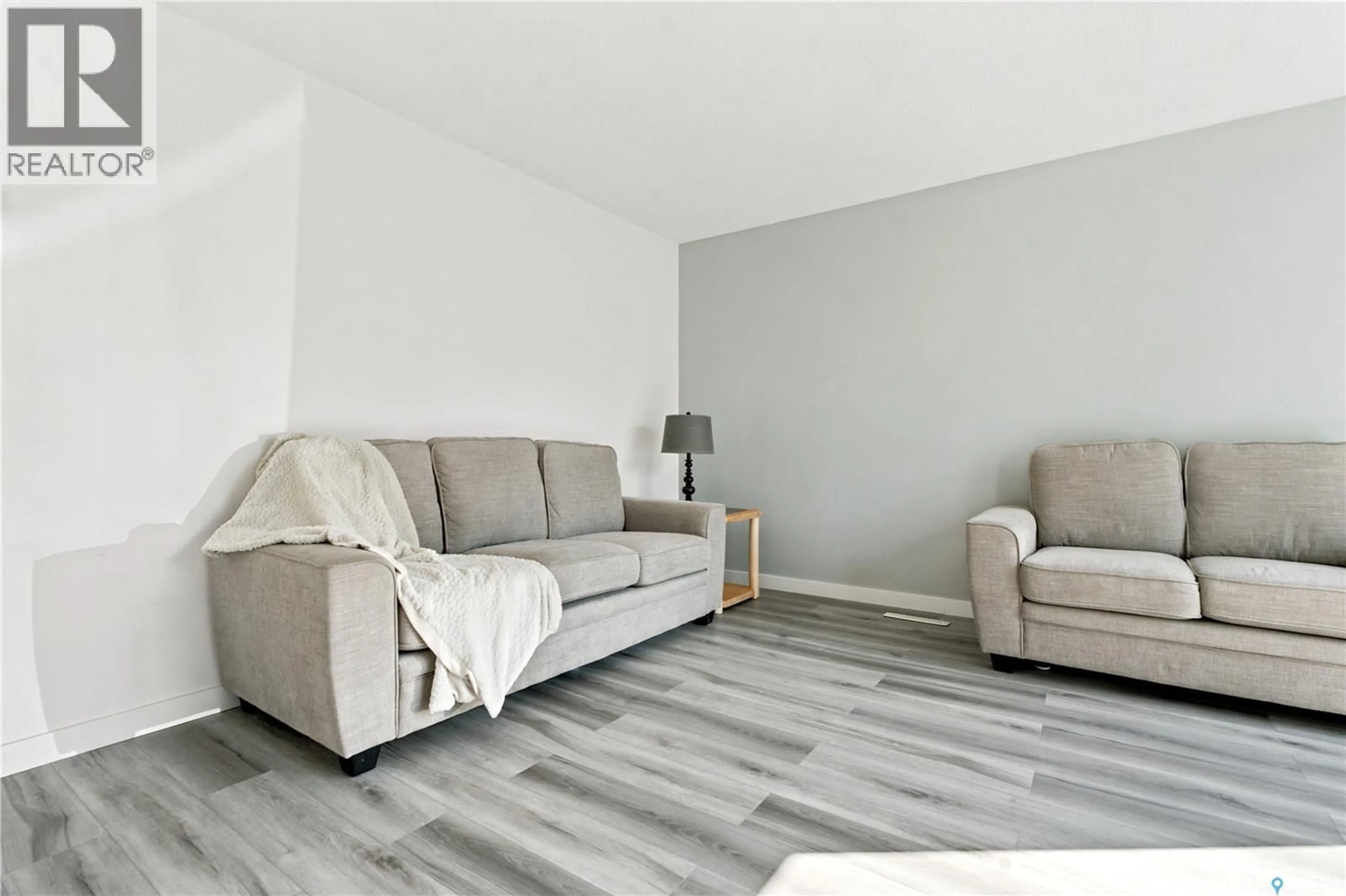 Living room with furniture, wood/laminate floor for 55 TRIDENT CRESCENT, Saskatoon Saskatchewan S7M0P7