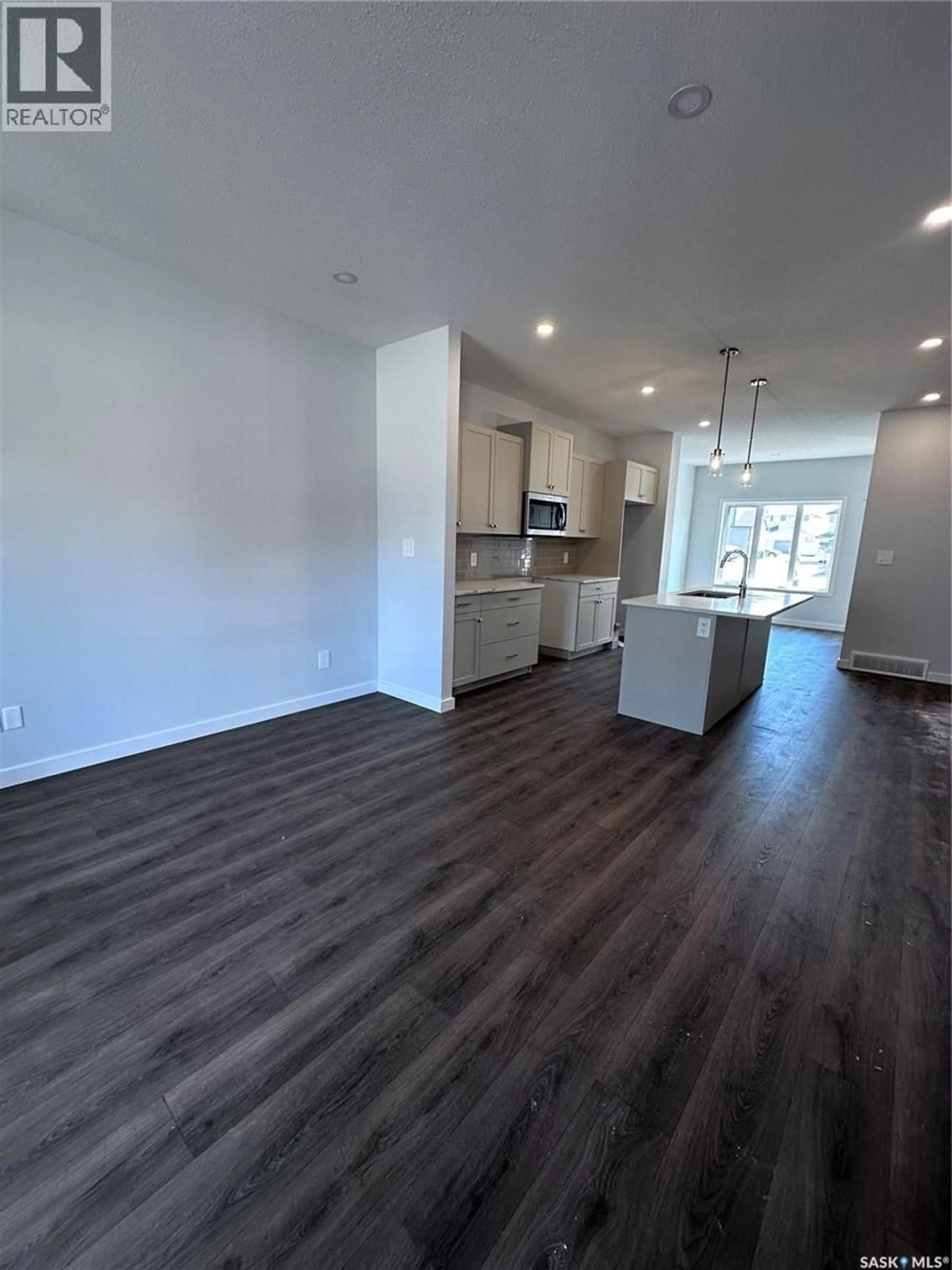 Open concept kitchen, wood/laminate floor for 3115 BOWEN STREET, Regina Saskatchewan S4V4C6