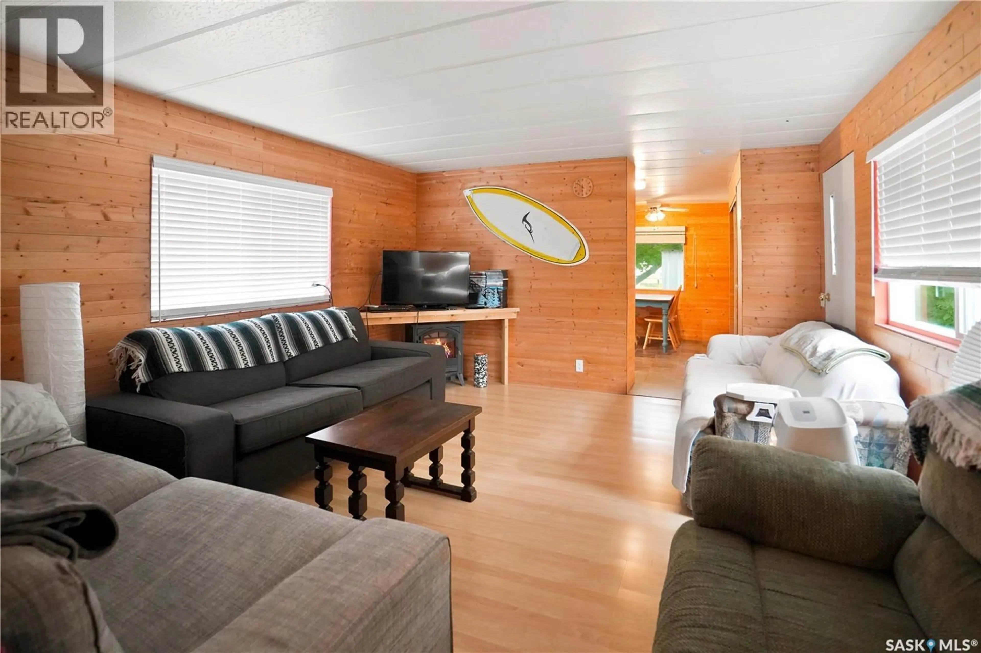 Living room with furniture, wood/laminate floor for 461 POPLAR CRESCENT, Aquadeo Saskatchewan S0M1E0