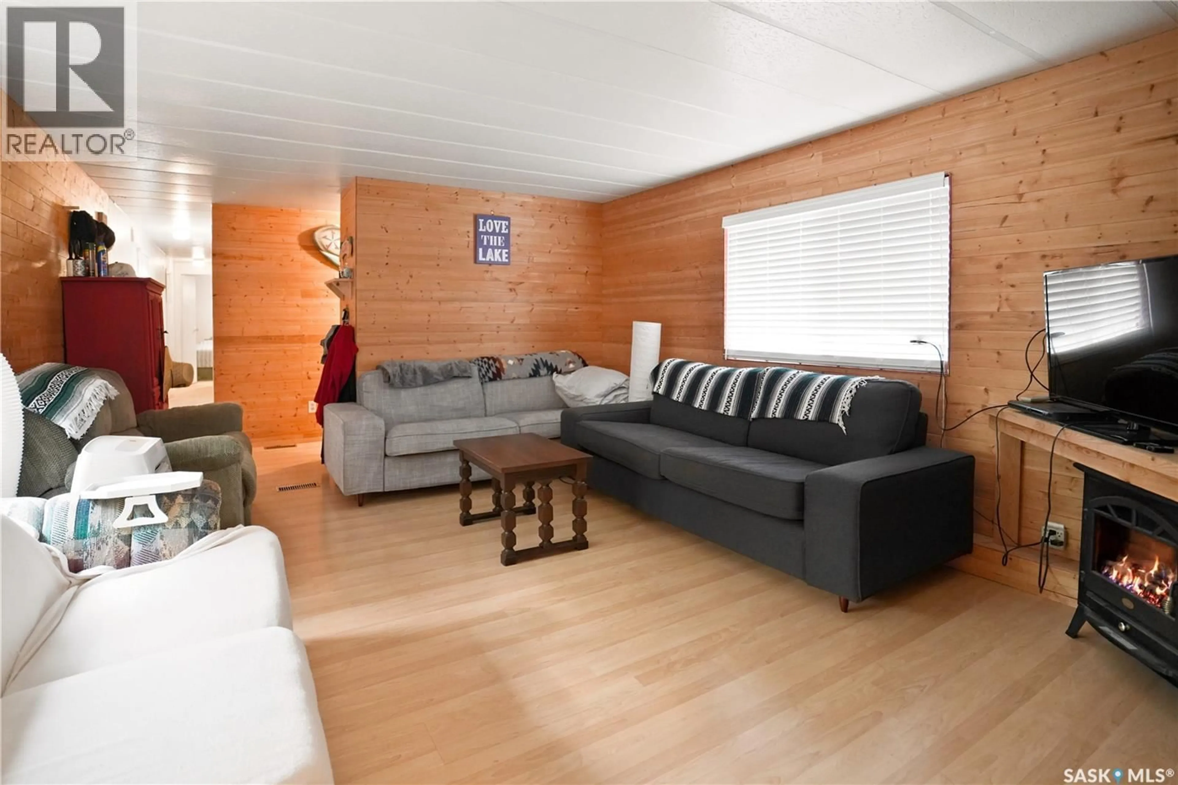 Living room with furniture, wood/laminate floor for 461 POPLAR CRESCENT, Aquadeo Saskatchewan S0M1E0