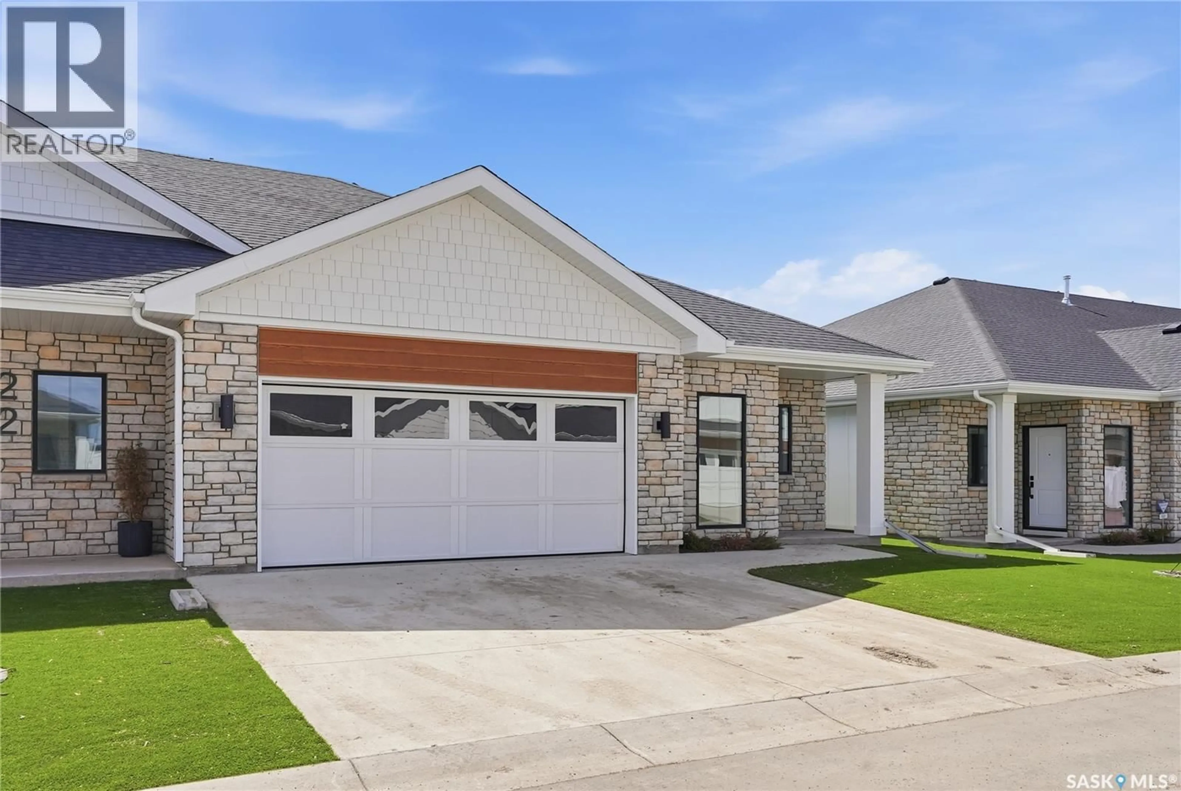 Home with brick exterior material, street for 20 BRIGHTON BOULEVARD, Saskatoon Saskatchewan S7V1X1