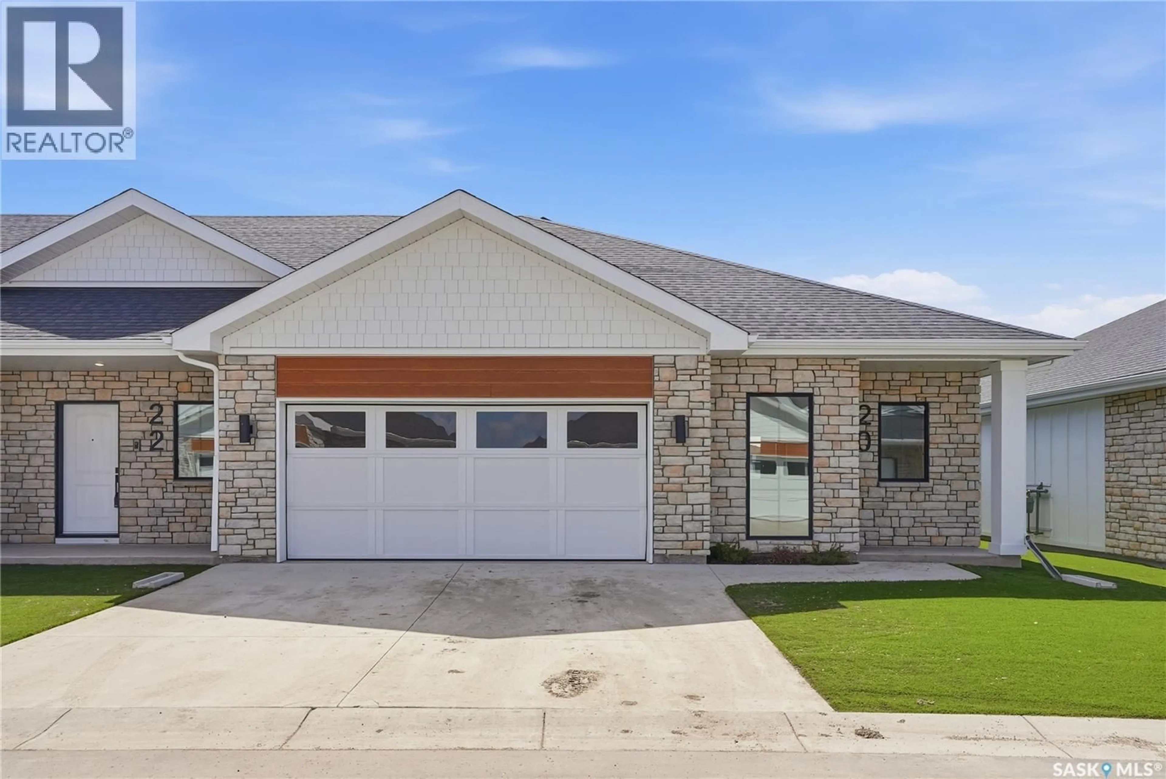 Home with brick exterior material, street for 20 BRIGHTON BOULEVARD, Saskatoon Saskatchewan S7V1X1
