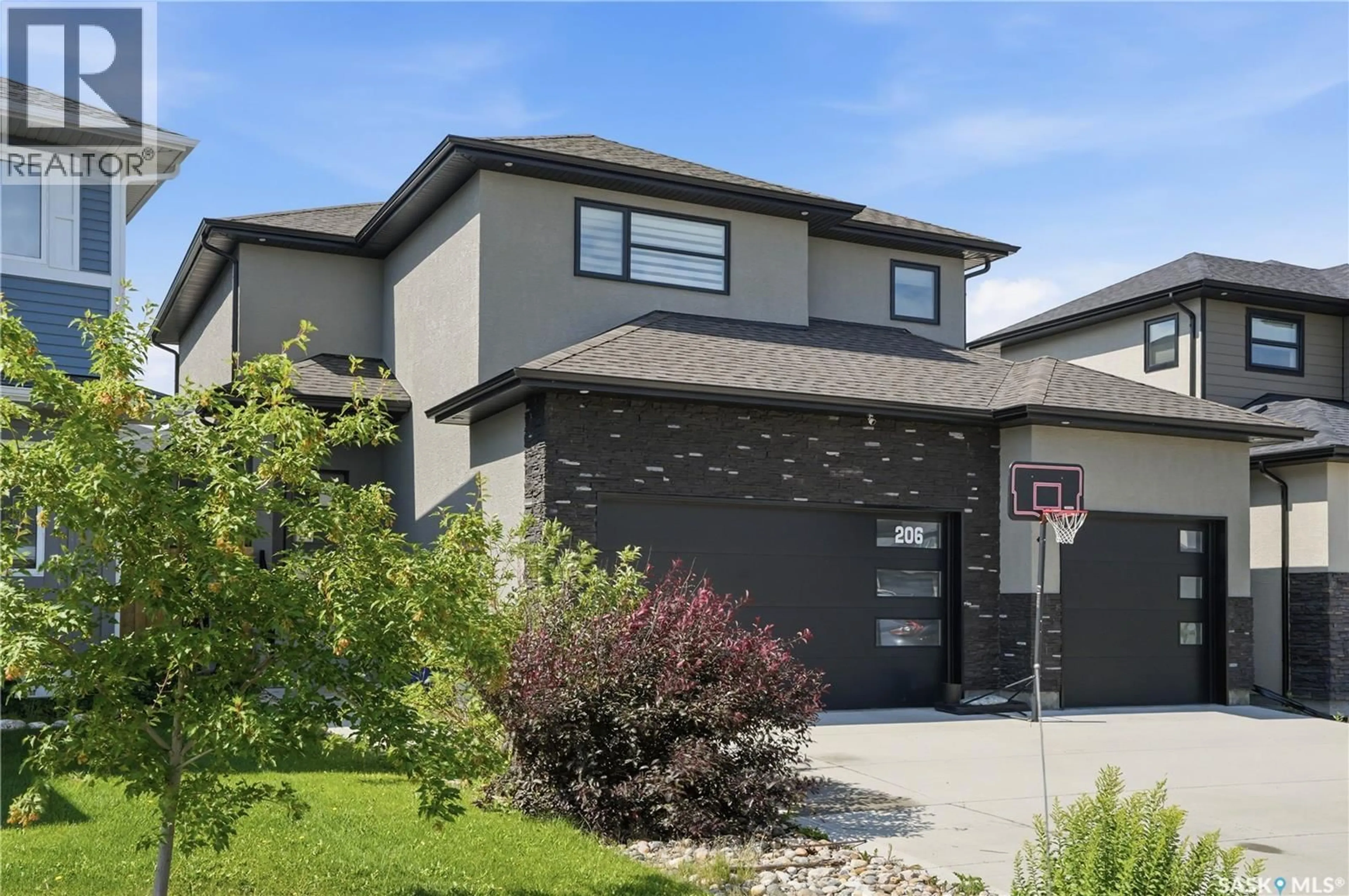 Home with brick exterior material, street for 206 KENASCHUK UNION, Saskatoon Saskatchewan S7W0Y3