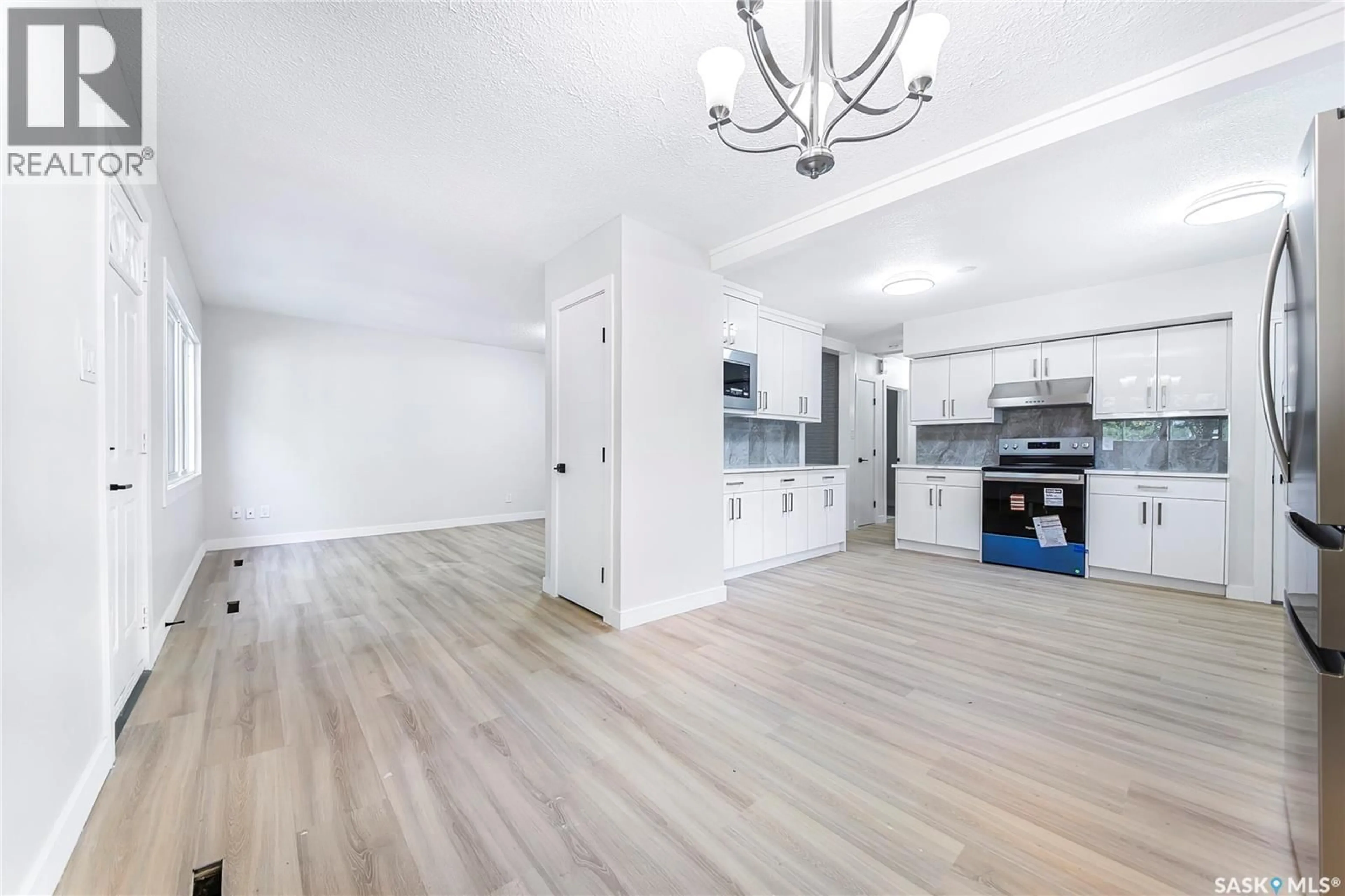 Open concept kitchen, wood/laminate floor for 451 R AVENUE S, Saskatoon Saskatchewan S7M2Z4